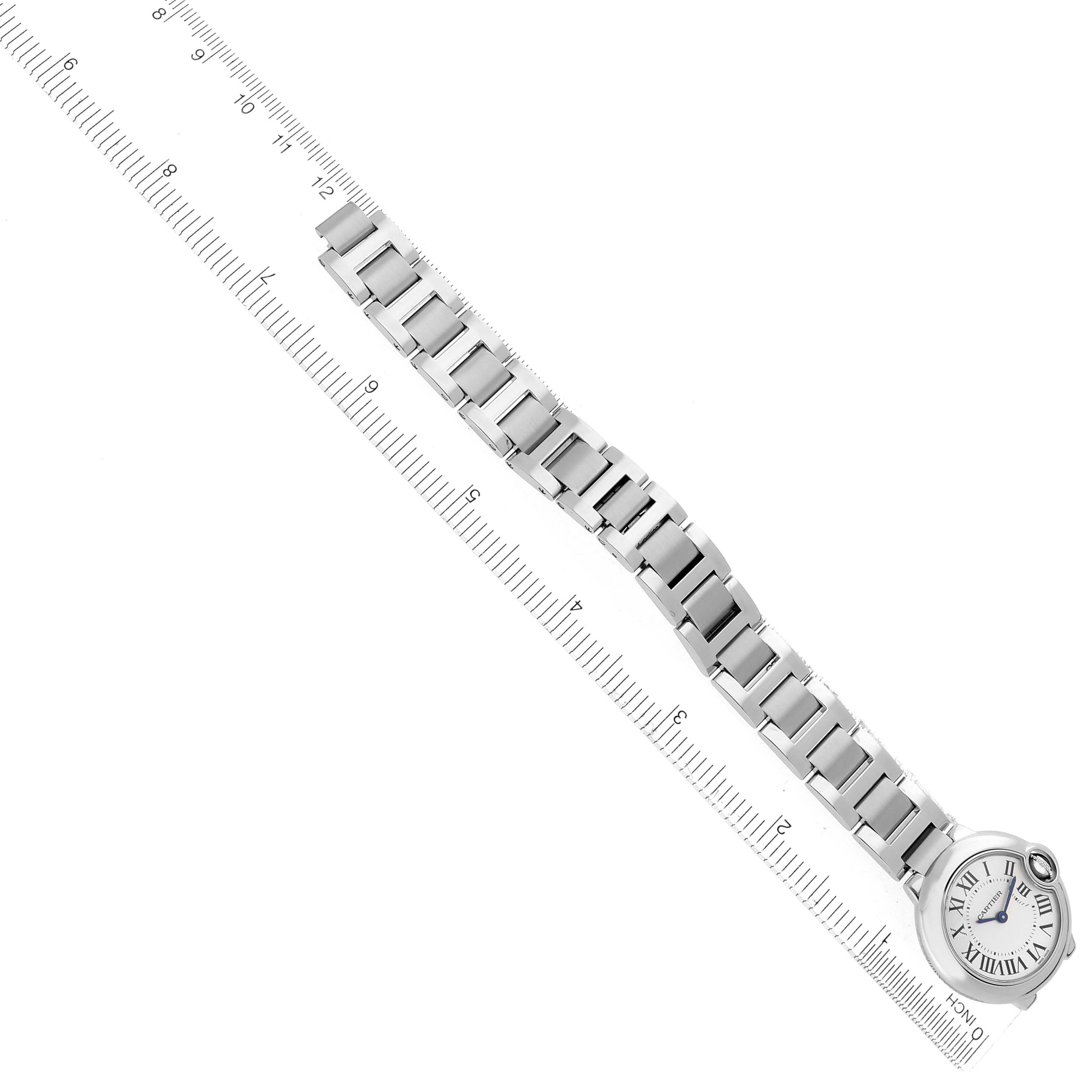 The image shows the Cartier Ballon Bleu W69010Z4 Women's Stainless Steel Silver Dial W69010Z4 Women's Stainless Steel Silver Dial watch from a top-down angle, highlighting the bracelet and face next to a ruler for scale.
