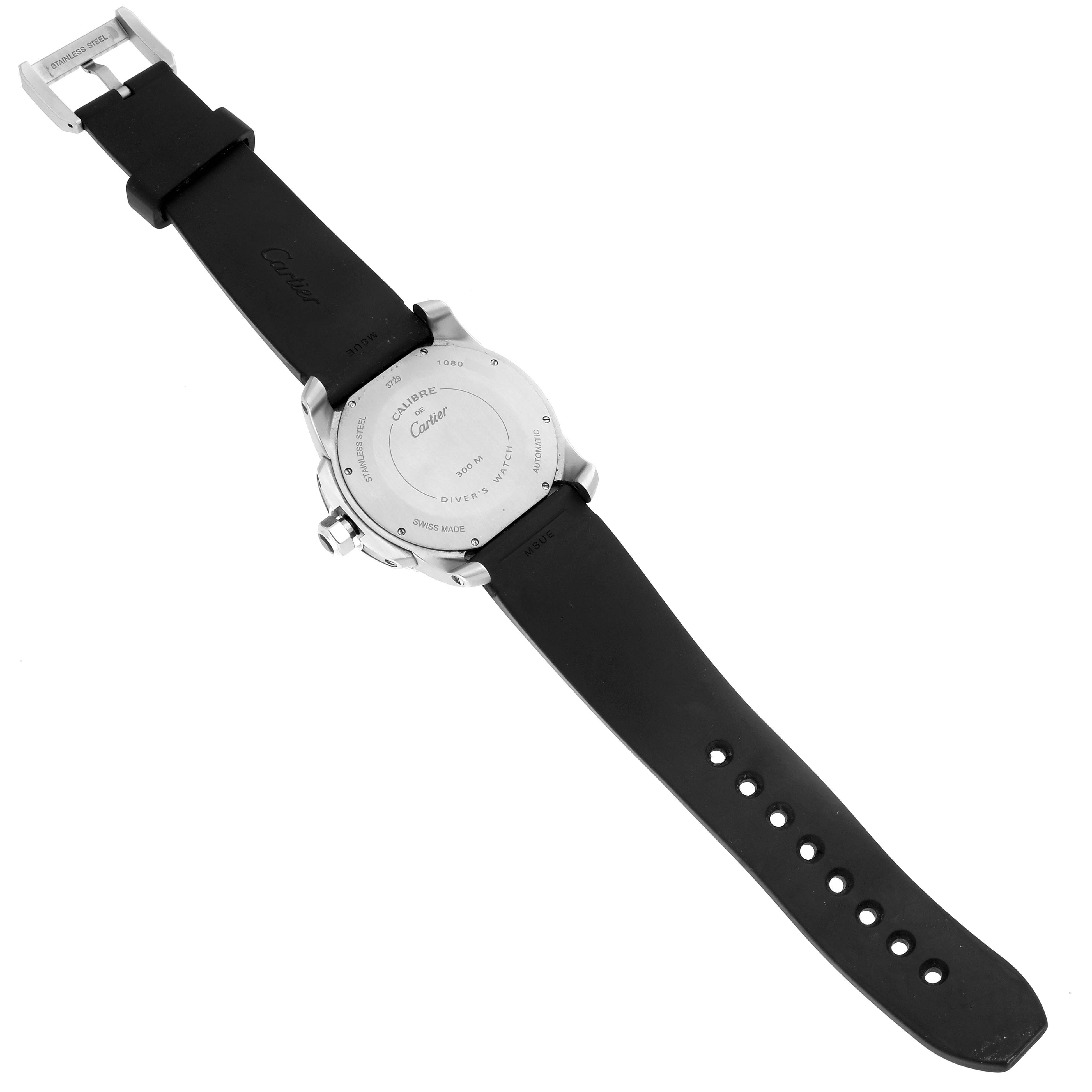 The Calibre de Cartier watch is shown from the back, displaying the case back, strap, and clasp.