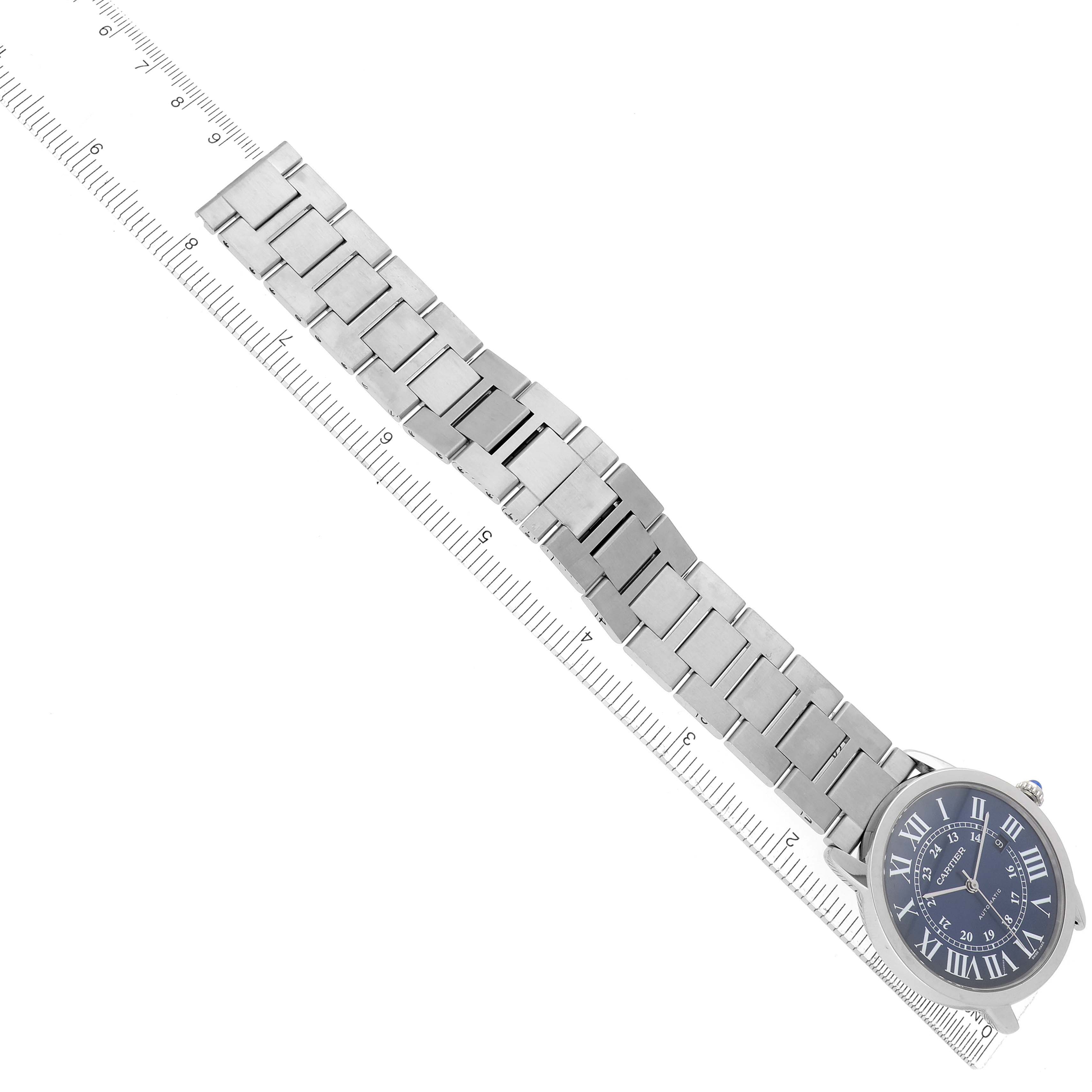 The image shows a Cartier Ronde WSRN0023 Men
s Stainless Steel Blue Dial WSRN0023 Men
s Stainless Steel Blue Dial watch at an angle, highlighting the strap and face alongside a measurement ruler.