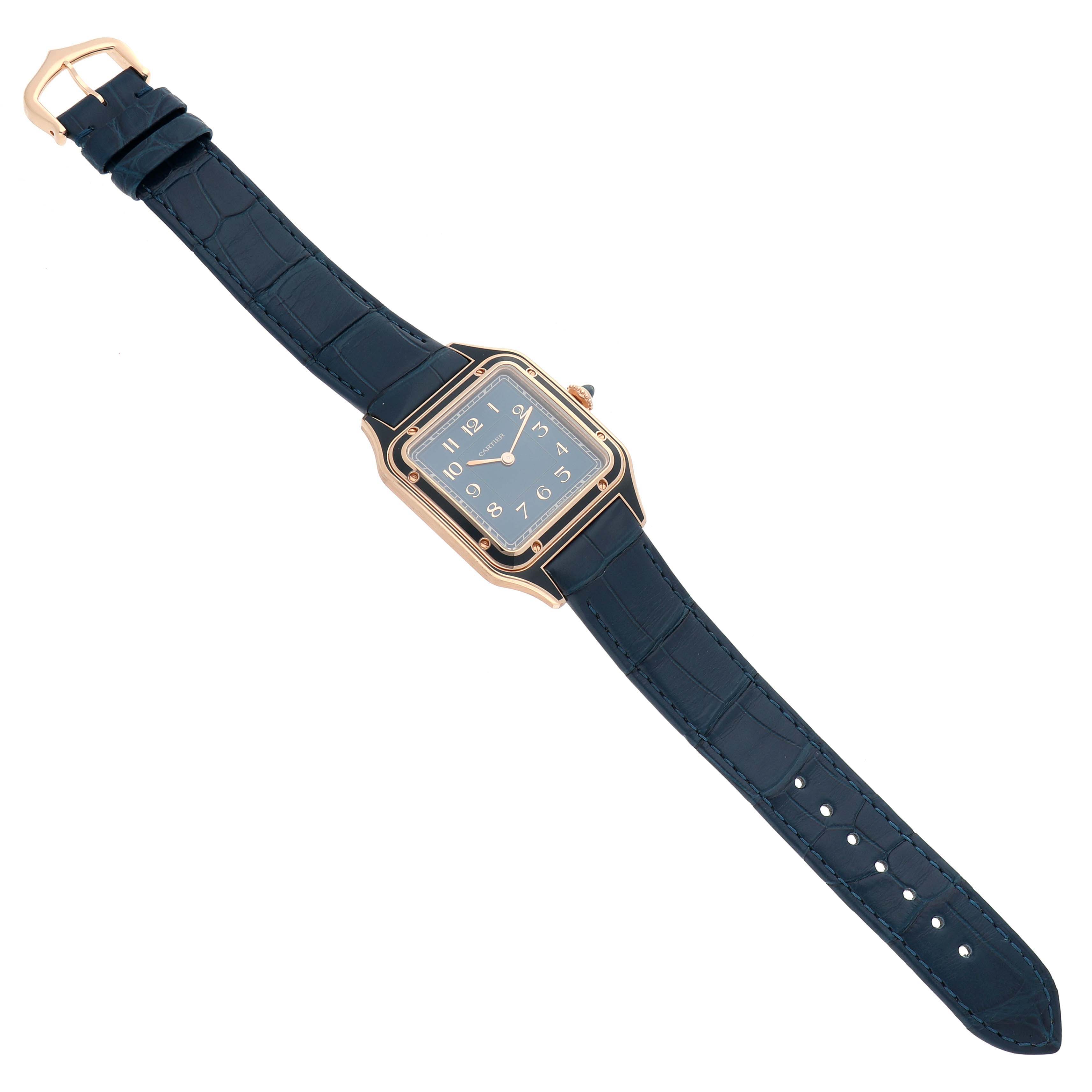 The Cartier Santos Dumont WGSA0098 Men
s Rose Gold Blue Dial WGSA0098 Men
s Rose Gold Blue Dial watch is shown from a top-down angle, displaying its face, case, and full strap.