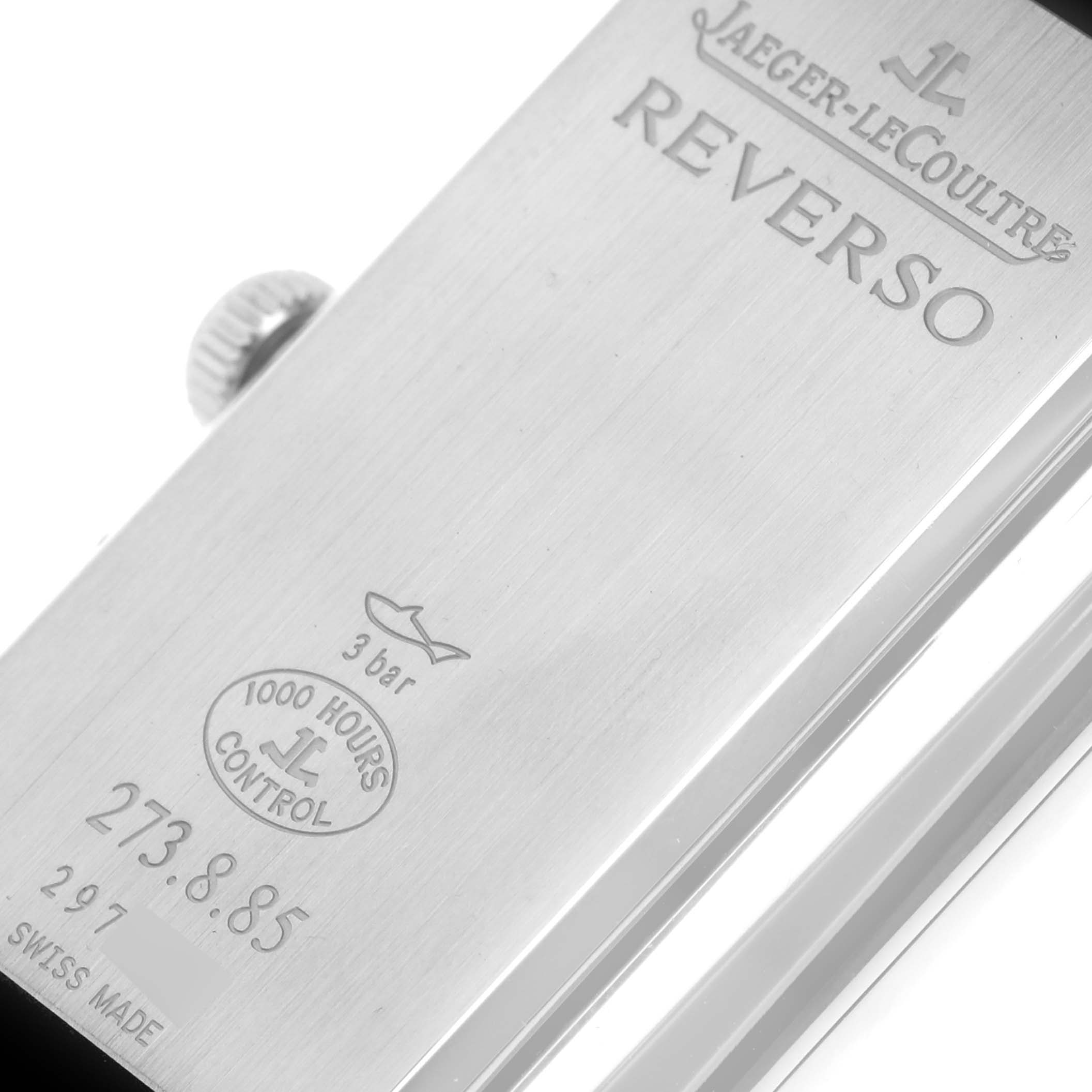 The image shows the back case of a Jaeger-LeCoultre Reverso watch, highlighting the engravings and crown.
