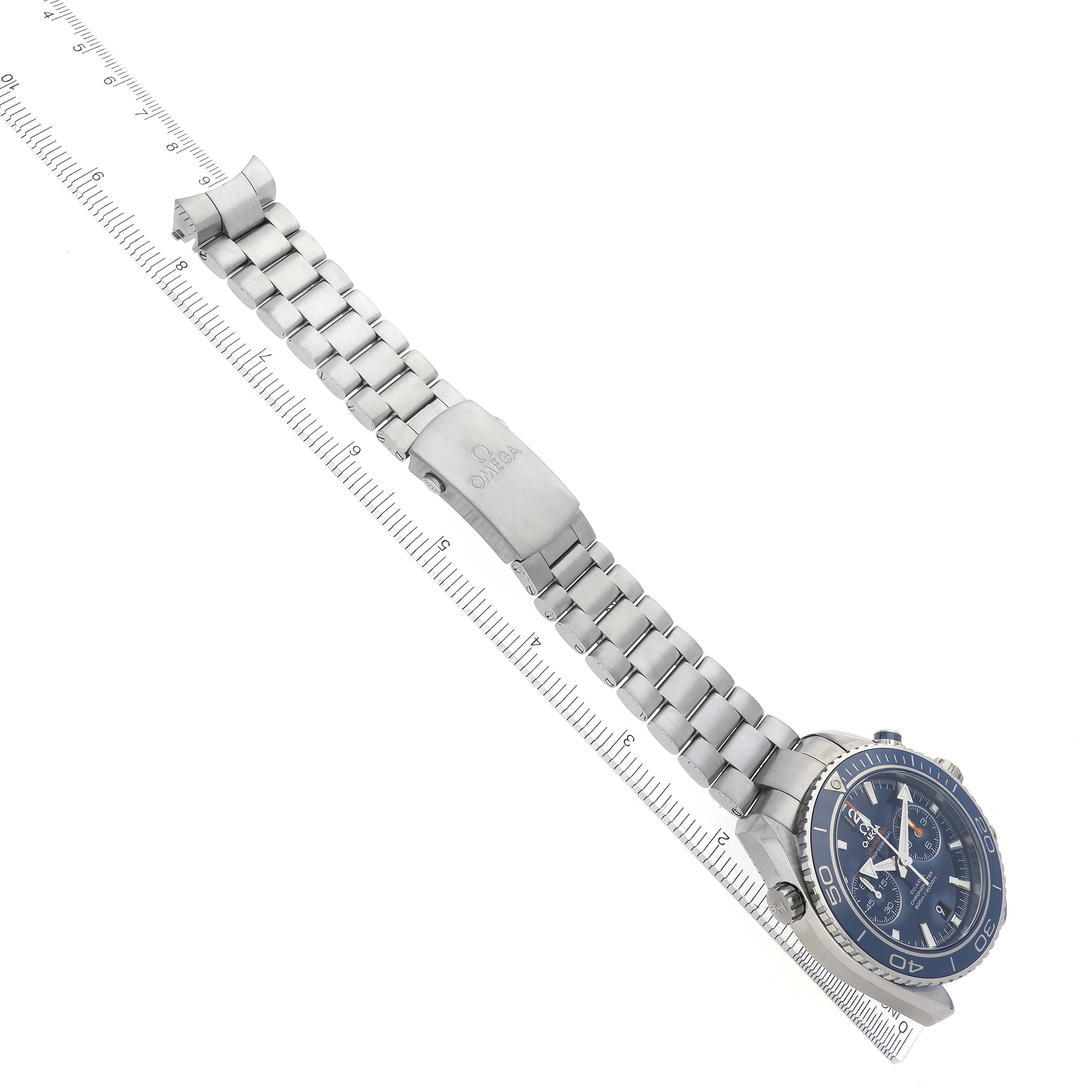 The Omega Planet Ocean 232.90.46.51.03.001 Men
s Titanium Blue Dial 232.90.46.51.03.001 Men
s Titanium Blue Dial watch is shown at an angled overhead view, displaying its face, bezel, and bracelet with a clasp.