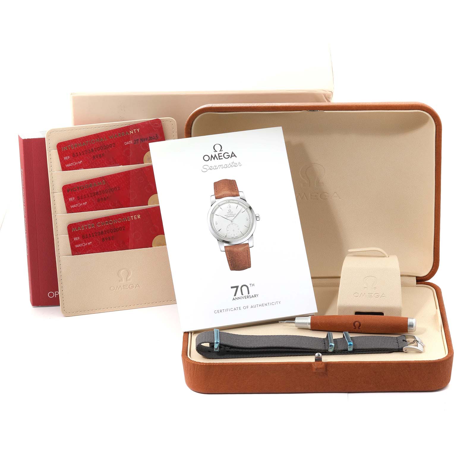 The image shows an Omega Seamaster 511.12.38.20.02.002 Men's White Gold Silver Dial 511.12.38.20.02.002 Men's White Gold Silver Dial watch set with warranty cards, authenticity certificate, tool, and additional straps from a front angle.