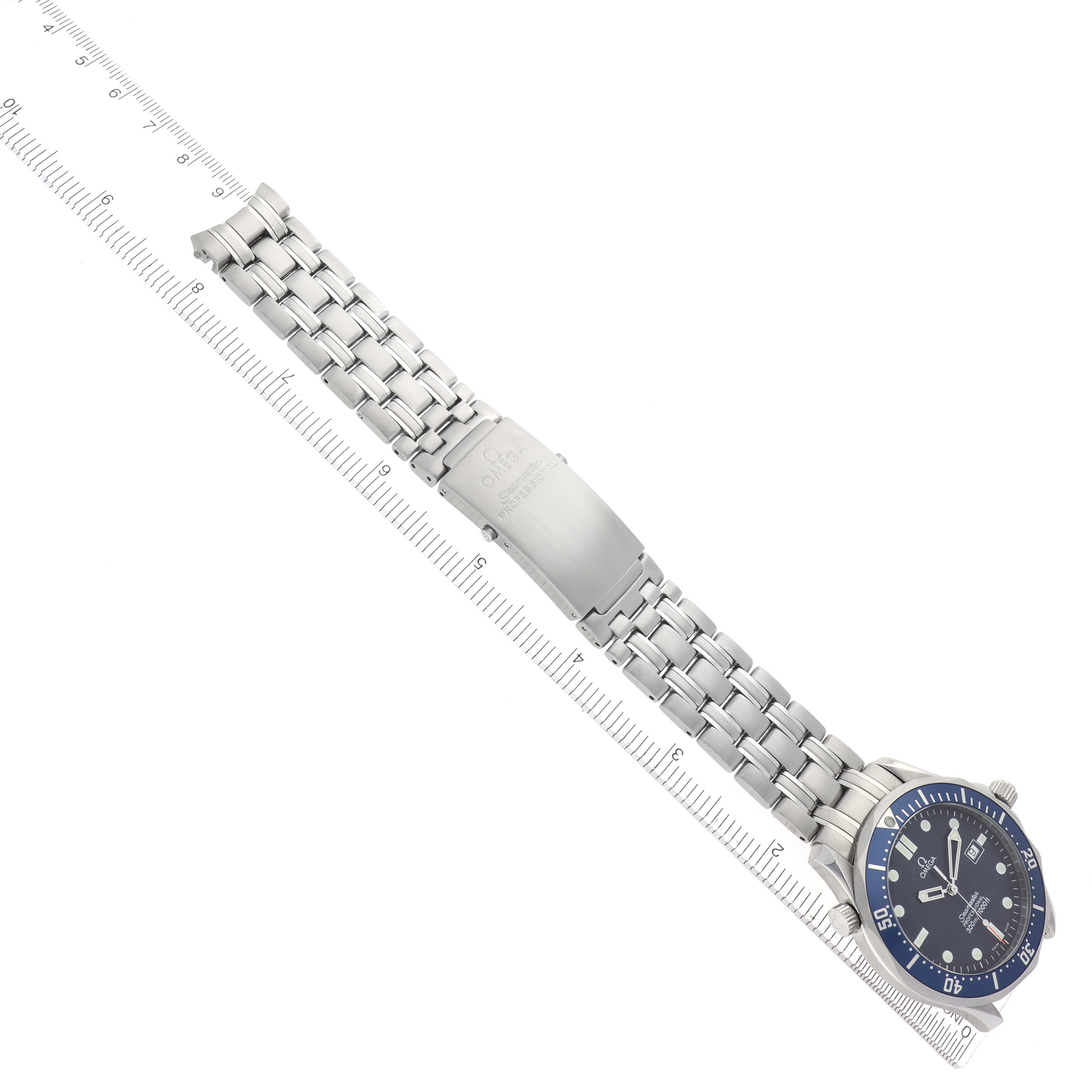 The Omega Seamaster 2541.80.00 Men
s Stainless Steel Blue Dial 2541.80.00 Men
s Stainless Steel Blue Dial watch is shown from a top-down angle, displaying its bracelet and bezel alongside a ruler for scale.