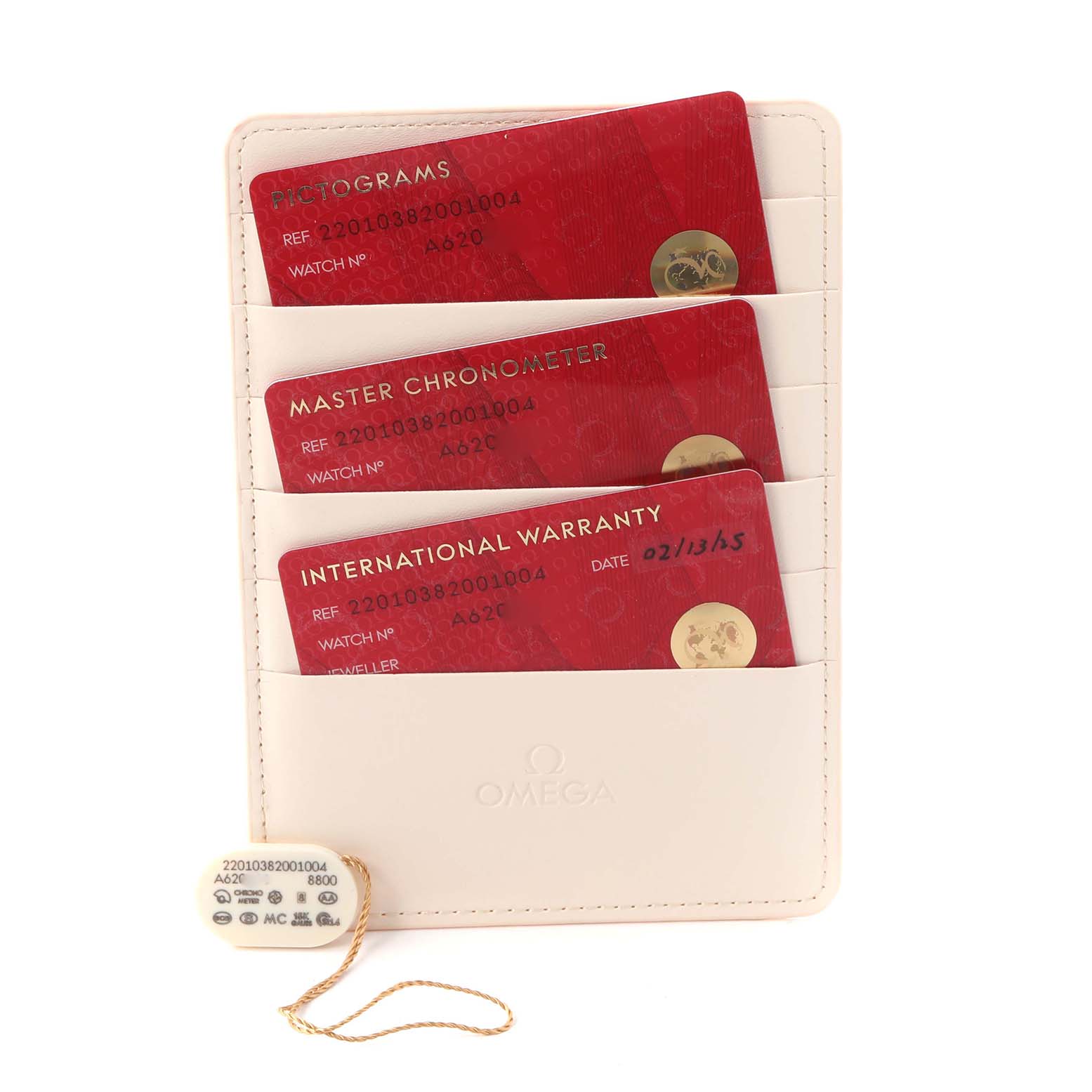 The image shows the Omega Aqua Terra 220.10.38.20.01.004 Men
s Stainless Steel Black Dial 220.10.38.20.01.004 Men
s Stainless Steel Black Dial model
s warranty and certification cards in a cream cardholder, with a tag attached.