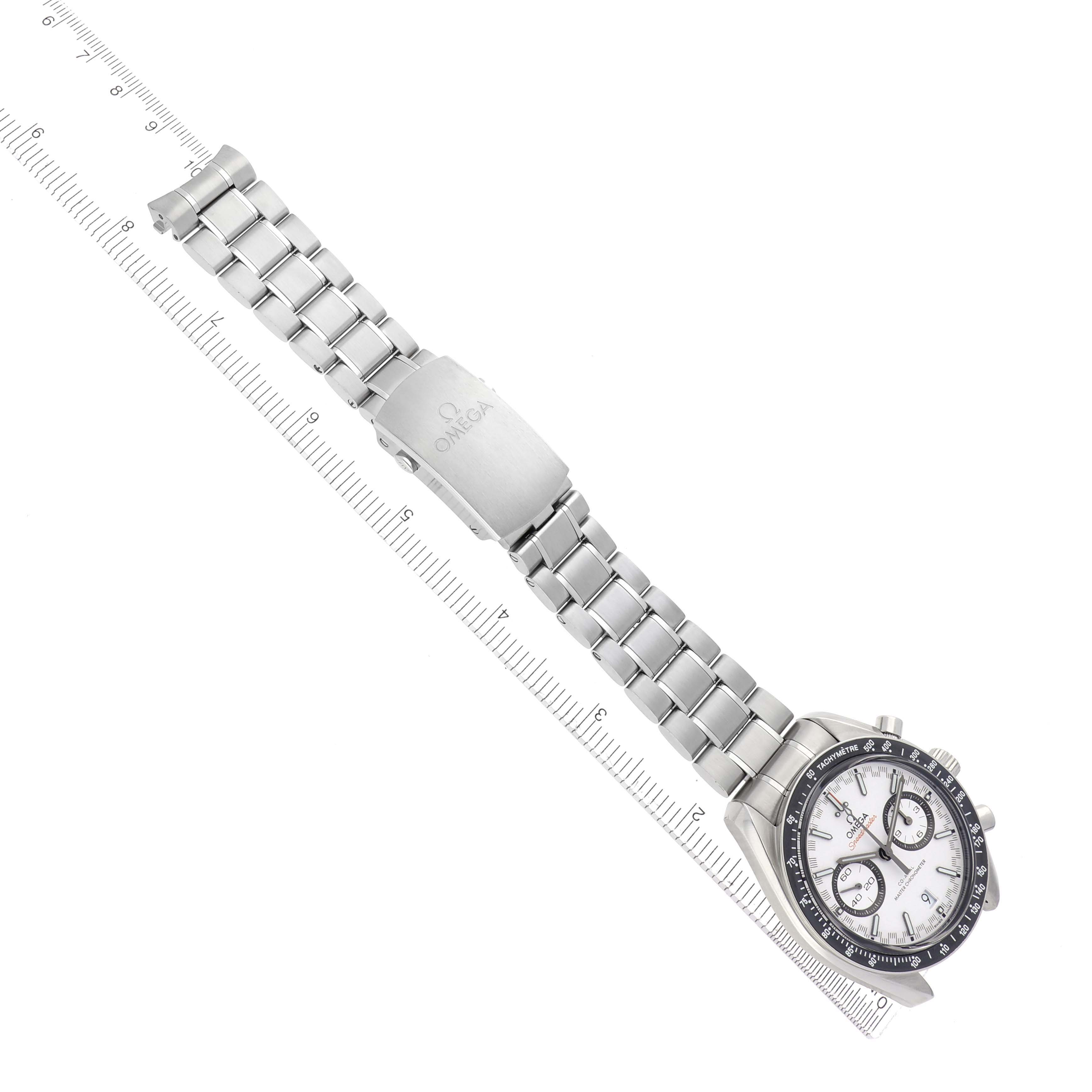 The Omega Speedmaster 329.30.44.51.04.001 Men
s Stainless Steel Silver Dial 329.30.44.51.04.001 Men
s Stainless Steel Silver Dial watch is shown from a top-down angle, displaying the bracelet, clasp, and face alongside a ruler.