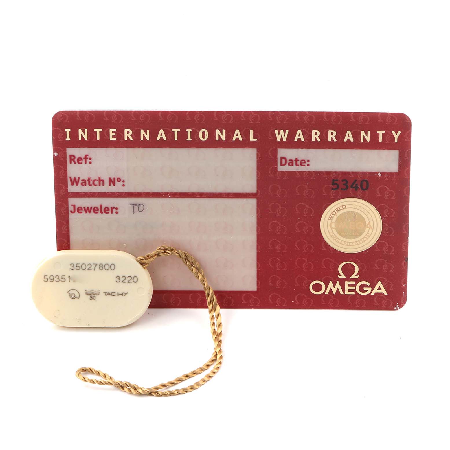 The image shows an Omega Speedmaster 3502.78.00 Men
s Stainless Steel Mother of Pearl Dial 3502.78.00 Men
s Stainless Steel Mother of Pearl Dial International Warranty card and a hang tag with a braided string attached.