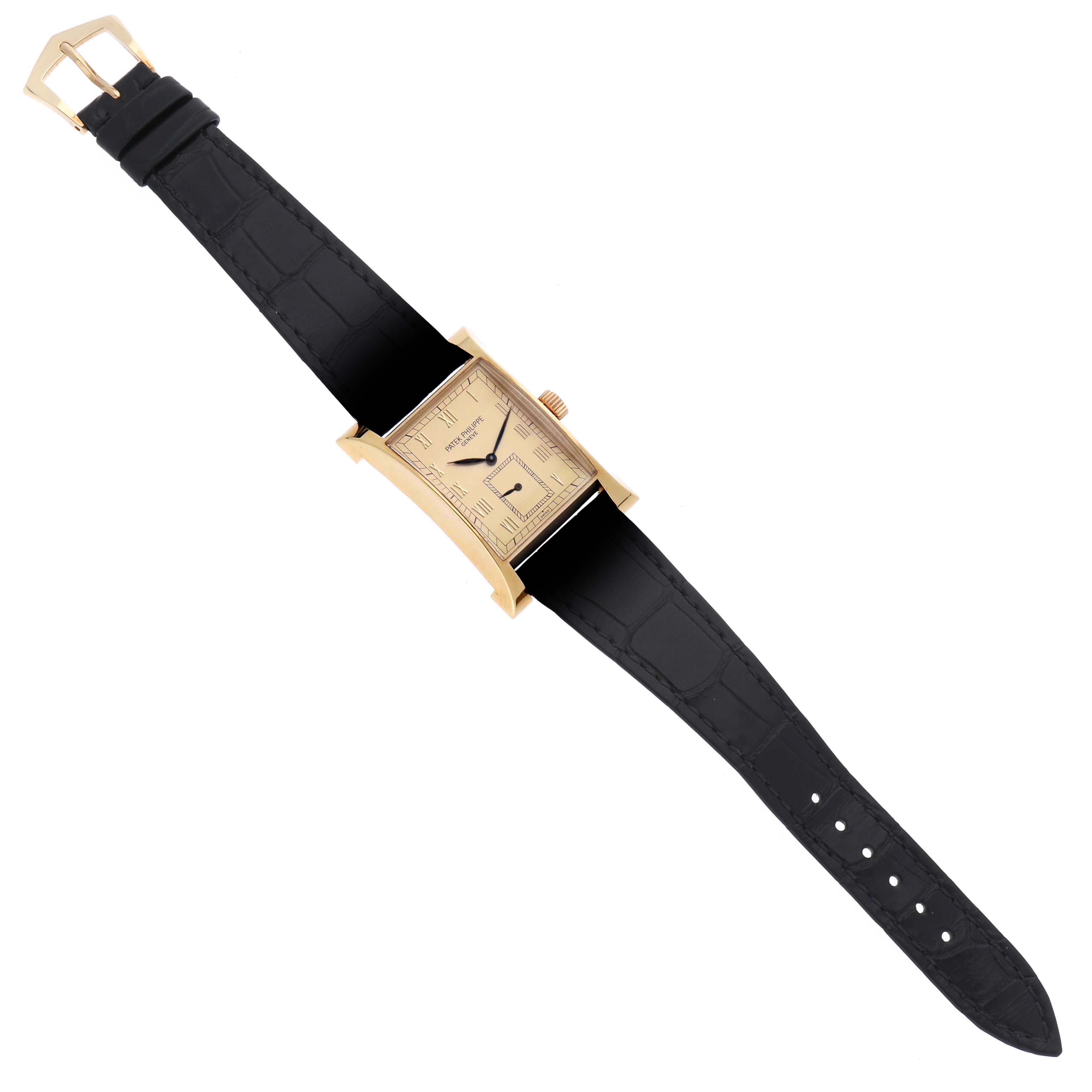 The image shows the Pagoda model by Patek Philippe from a top view, highlighting its rectangular case, gold finish, and leather strap.