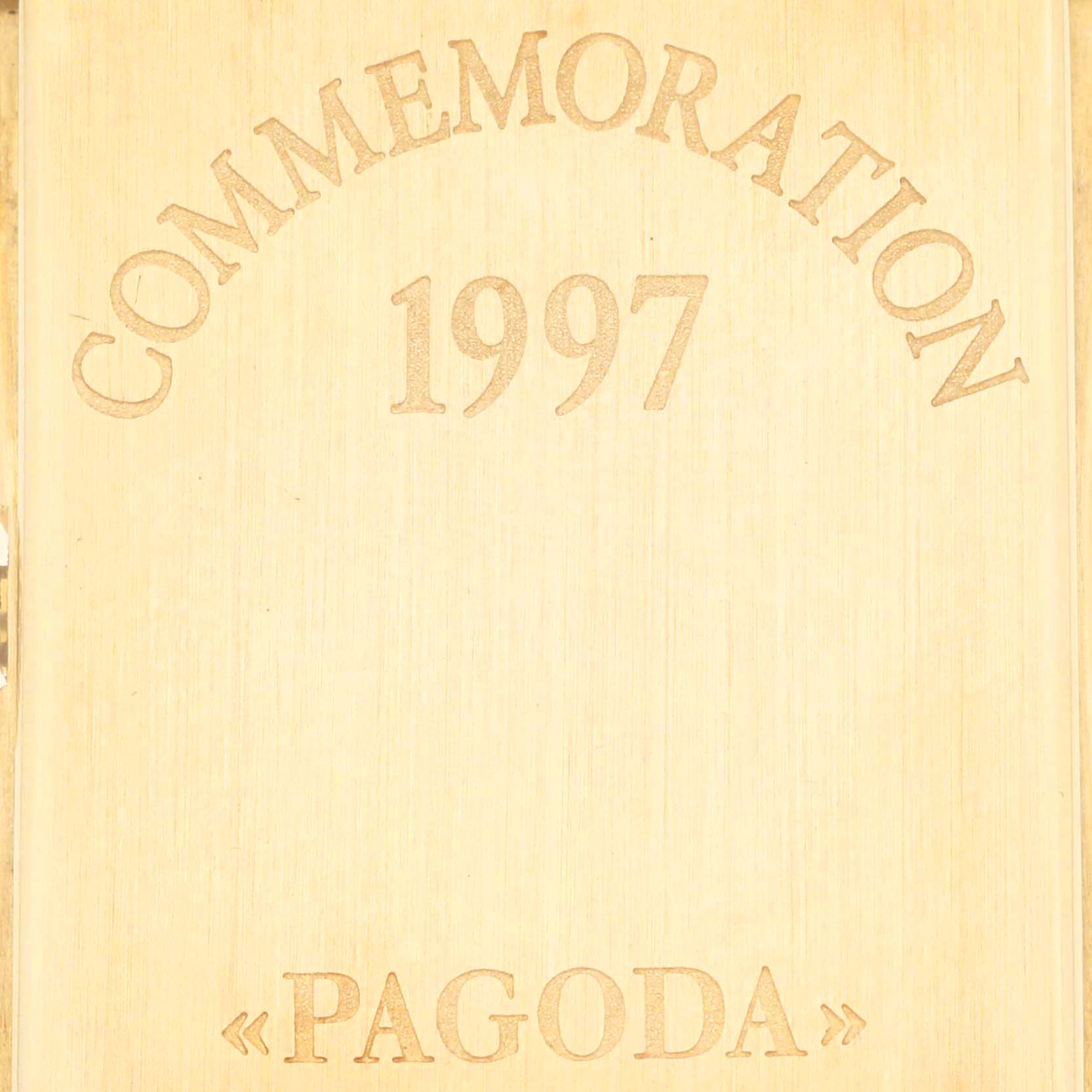 The image shows an engraved surface reading "COMMEMORATION 1997 'PAGODA'," related to the Patek Philippe Pagoda 5500J Men's Yellow Gold Champagne Dial model.