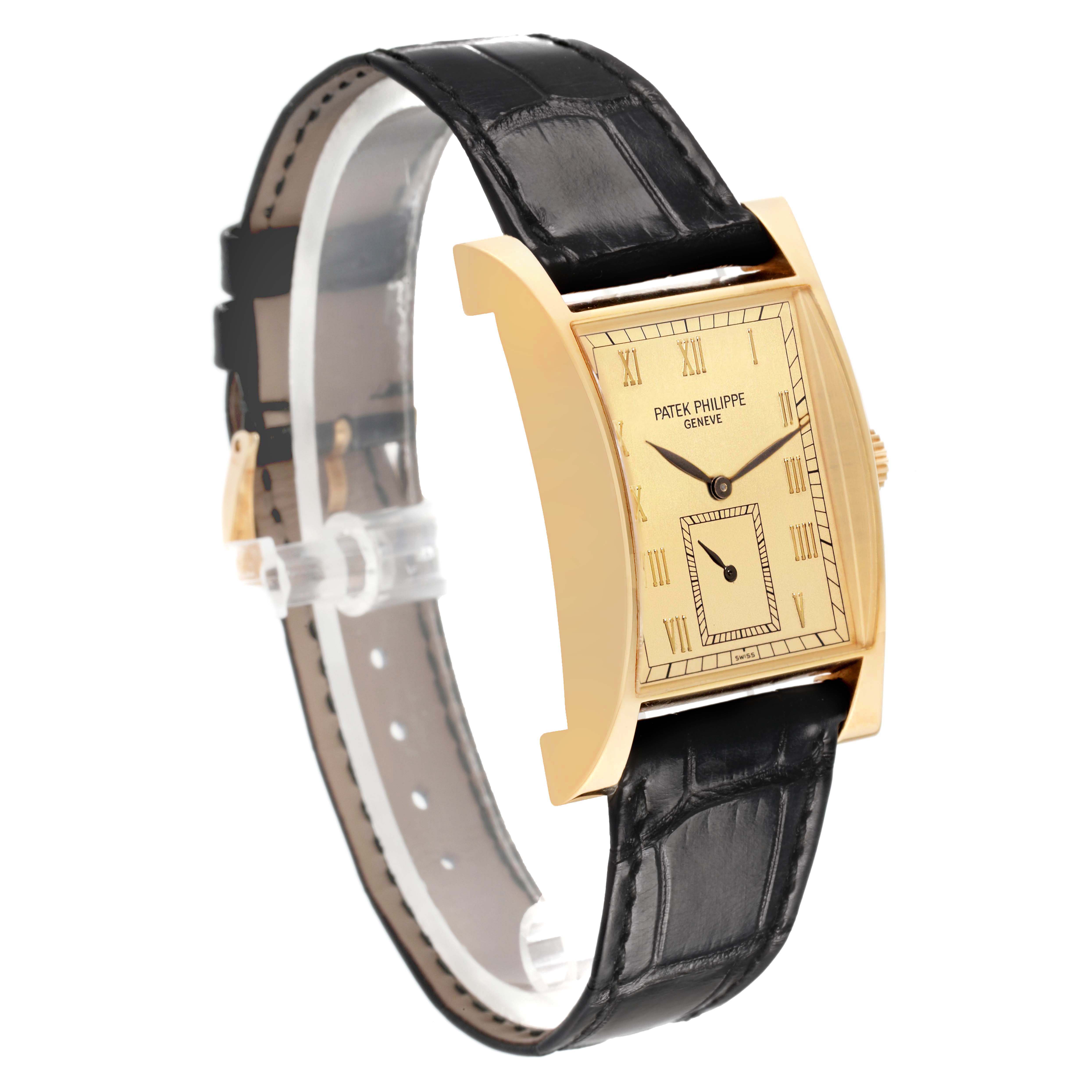 The Patek Philippe Pagoda 5500J Men's Yellow Gold Champagne Dial watch is shown at an angled side view, highlighting its rectangular dial and leather strap.