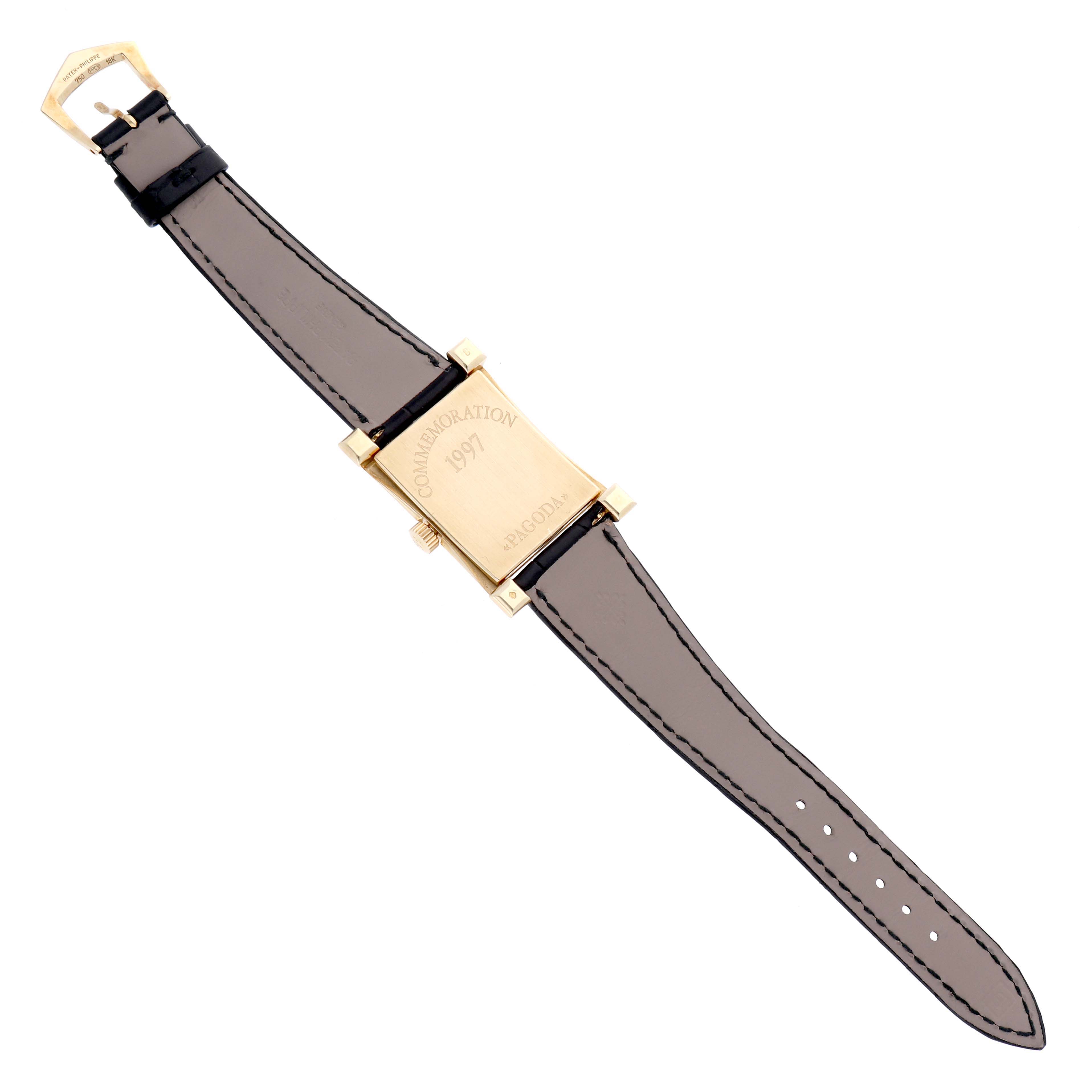 The image shows the back view of a Patek Philippe Pagoda 5500J Men's Yellow Gold Champagne Dial 5500J Men's Yellow Gold Champagne Dial watch, revealing the strap and case back, marked with the commemoration date "1997".