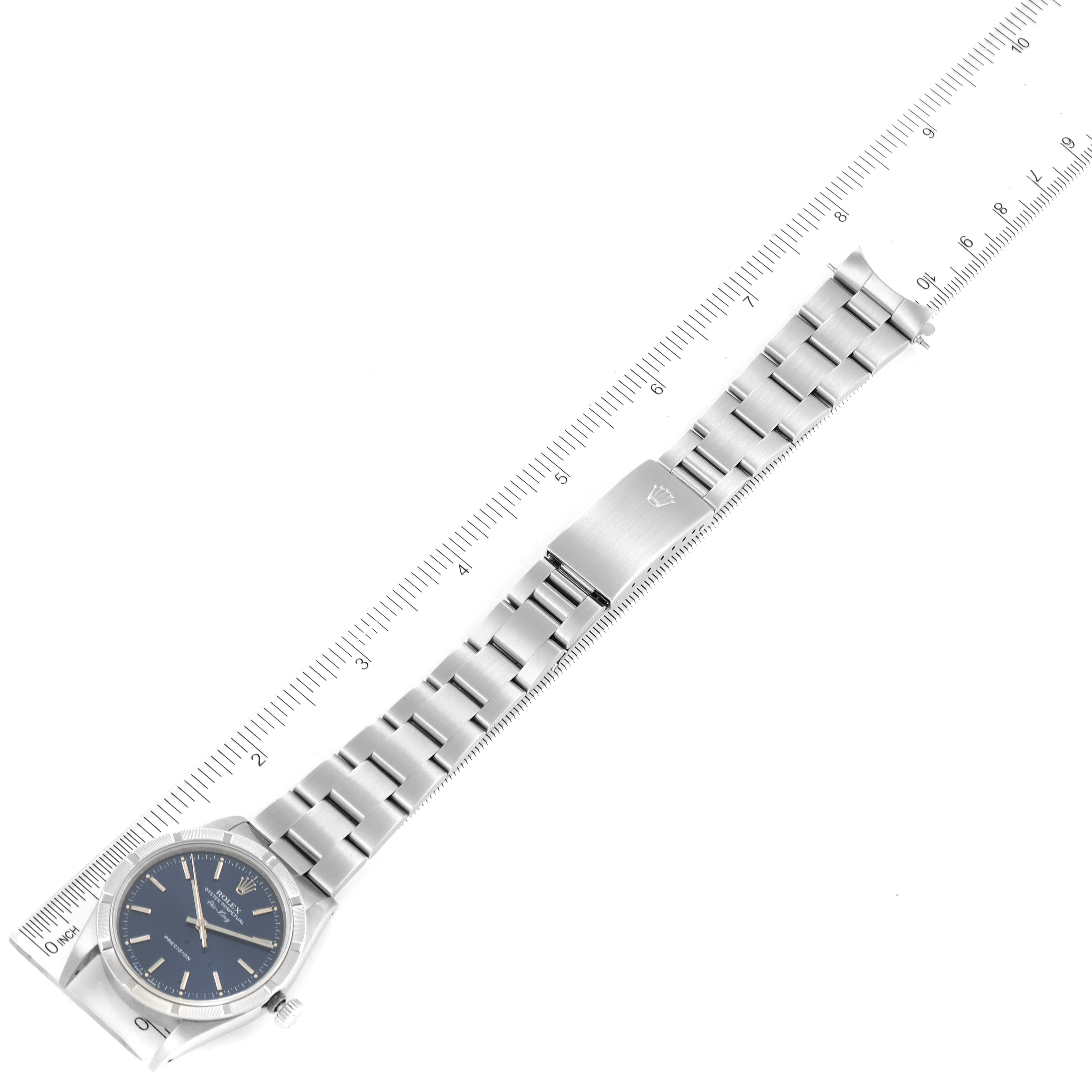 The image shows a top view of a Rolex Air-King 14010 Men's Stainless Steel Blue Dial 14010 Men's Stainless Steel Blue Dial watch with its bracelet fully extended next to a ruler.