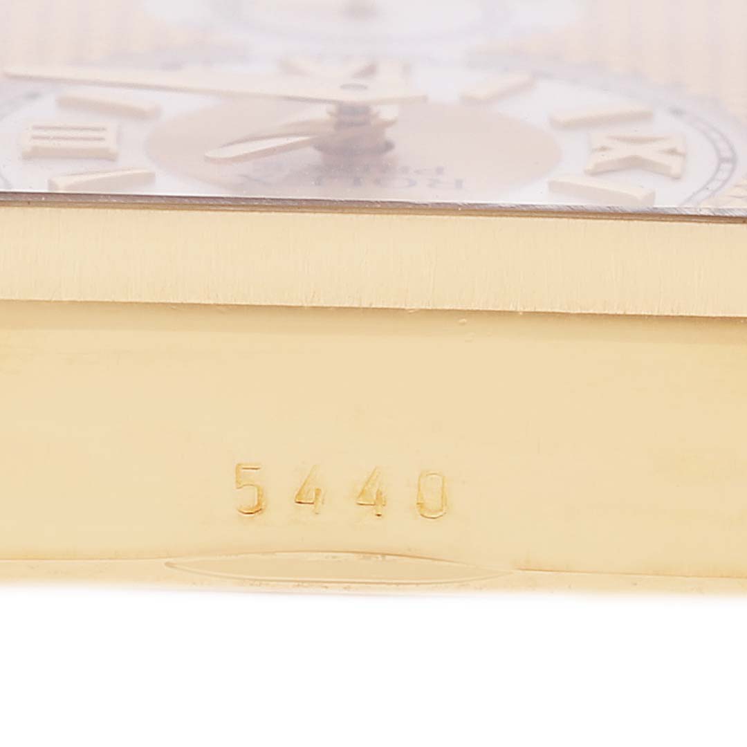 This close-up image of a Rolex Cellini 5440 Men
s Yellow Gold Champagne Dial 5440 Men
s Yellow Gold Champagne Dial model shows part of the watch
s dial, case side, and the number "5440" engraved on its gold surface.