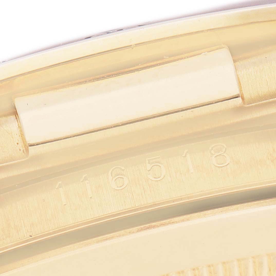 The image shows a close-up of the clasp and serial number on the Rolex Daytona 116518 Men
s Yellow Gold Blue Dial 116518 Men
s Yellow Gold Blue Dial watch.