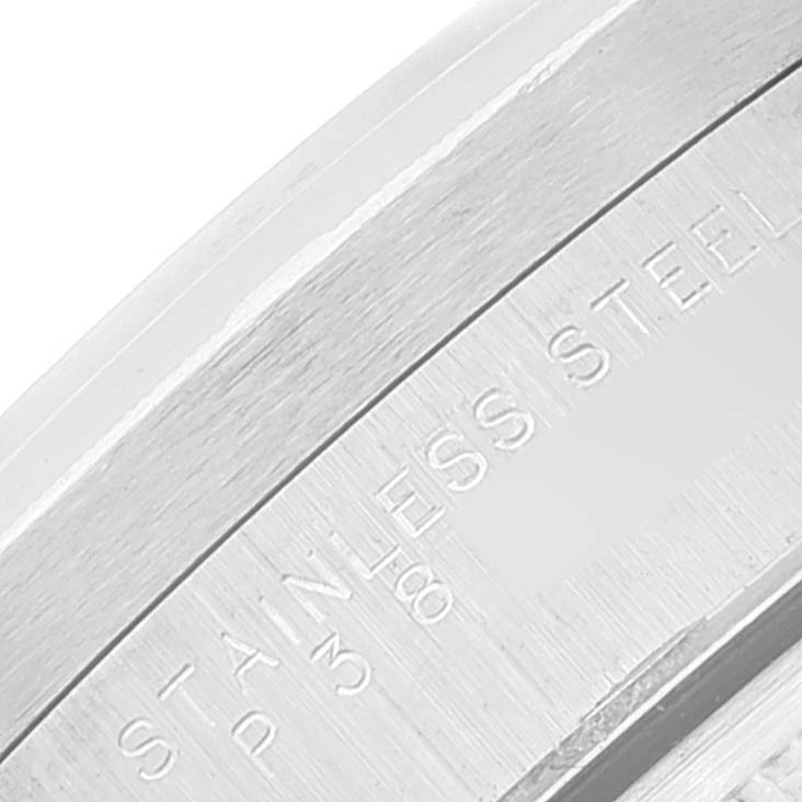 This close-up image shows the engraved "STAINLESS STEEL" text on the bezel of a Rolex Date 15210 Men's Stainless Steel Pink Dial 15210 Men's Stainless Steel Pink Dial model watch.