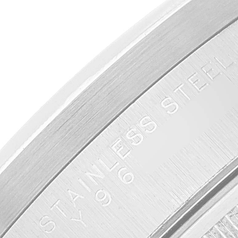 This close-up image of the Rolex Date 15210 Men's Stainless Steel Silver Dial 15210 Men's Stainless Steel Silver Dial watch displays part of the stainless steel case back.