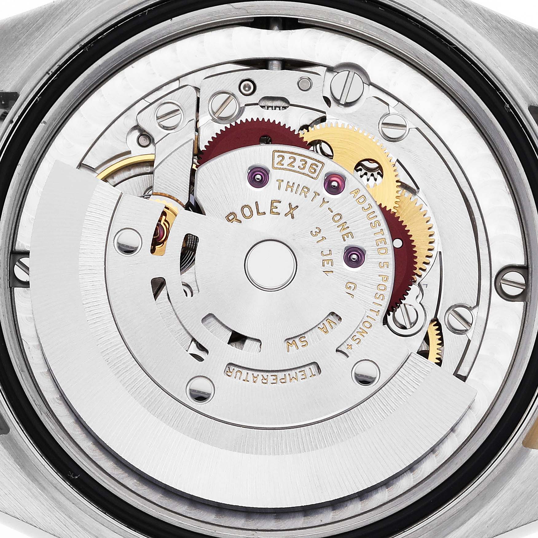 The image shows the movement of a Rolex Datejust watch, focusing on intricate gears and the rotor from a rear view.