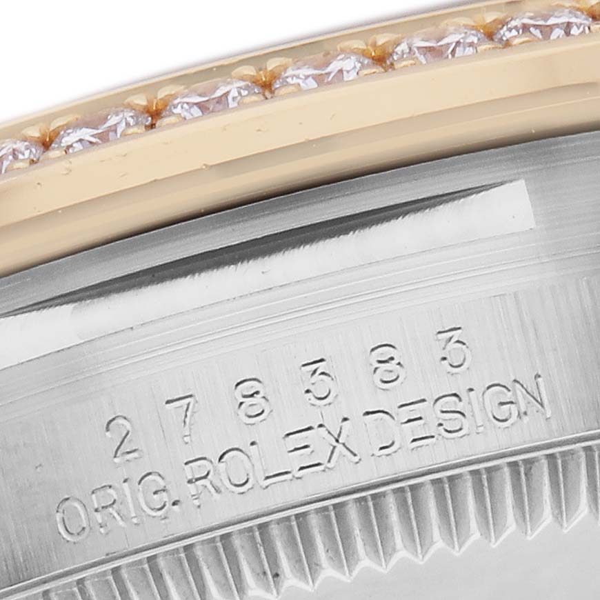 The image shows a close-up of the Rolex Datejust watch
s bezel and engraved serial number on the side.