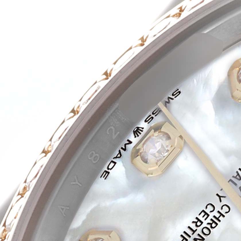 The image shows a close-up of the Rolex Datejust dial, bezel, and a diamond hour marker, viewed from an oblique angle.