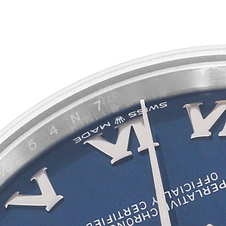 The image shows a close-up of the dial and bezel of a Mid-Size Rolex watch at an angle focused on the upper left section.