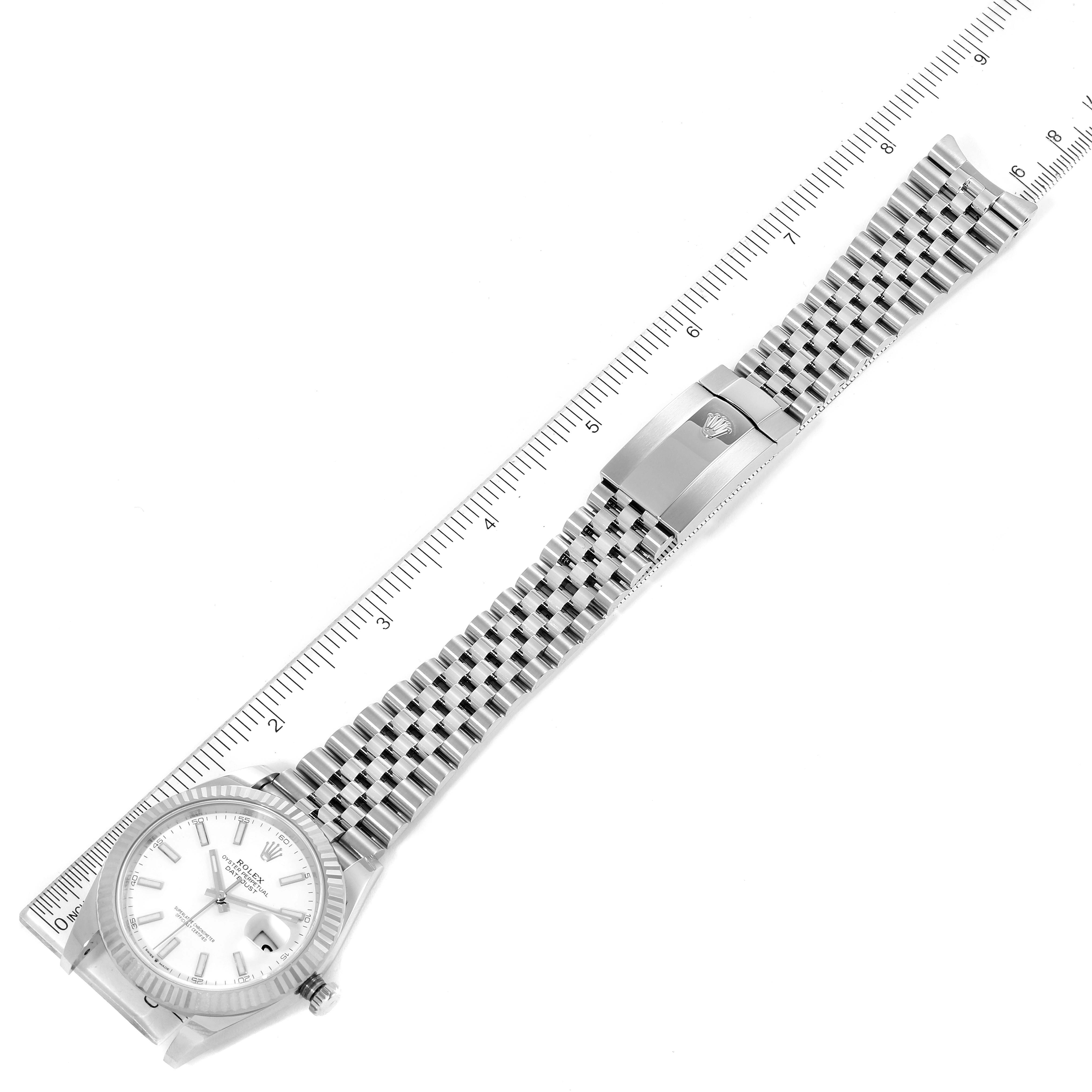 The image shows a Rolex Datejust 41 126334 Men
s Stainless Steel White Dial 126334 Men
s Stainless Steel White Dial watch laid flat, displaying the bracelet, clasp, and face with a ruler for scale.