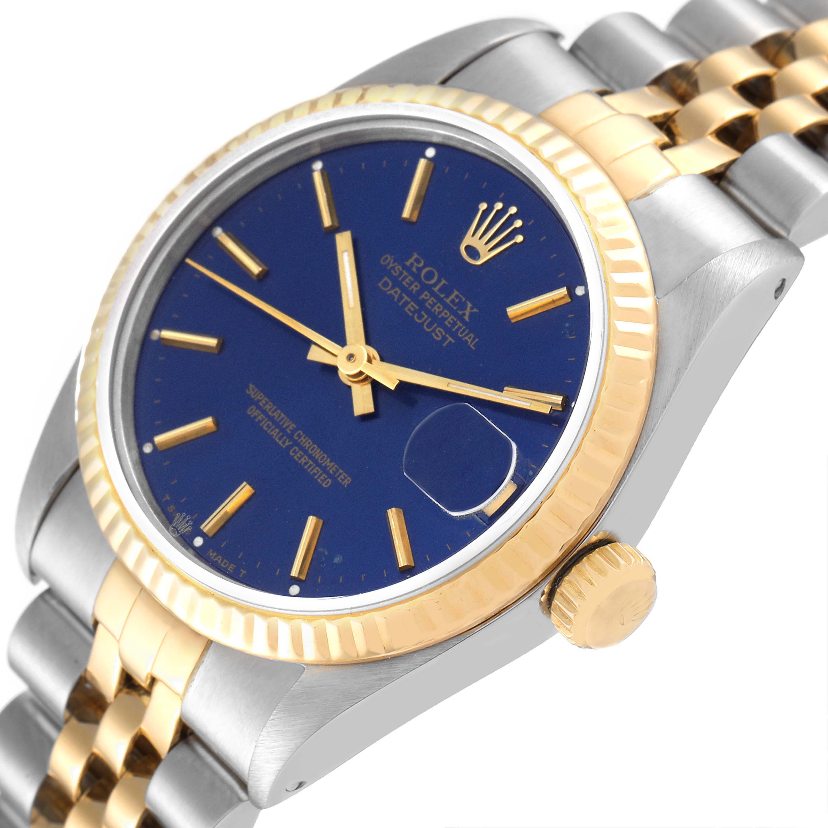 The image shows a side angle of a Rolex Mid-Size 68273 Women's Steel and Gold (two tone) Blue Dial 68273 Women's Steel and Gold (two tone) Blue Dial Datejust watch, highlighting the blue dial, bezel, crown, and part of the bracelet.