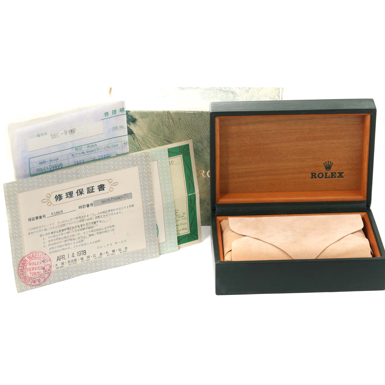 The image shows the open box, papers, and warranty for the Vintage Collection model by Rolex from a slightly above angle.