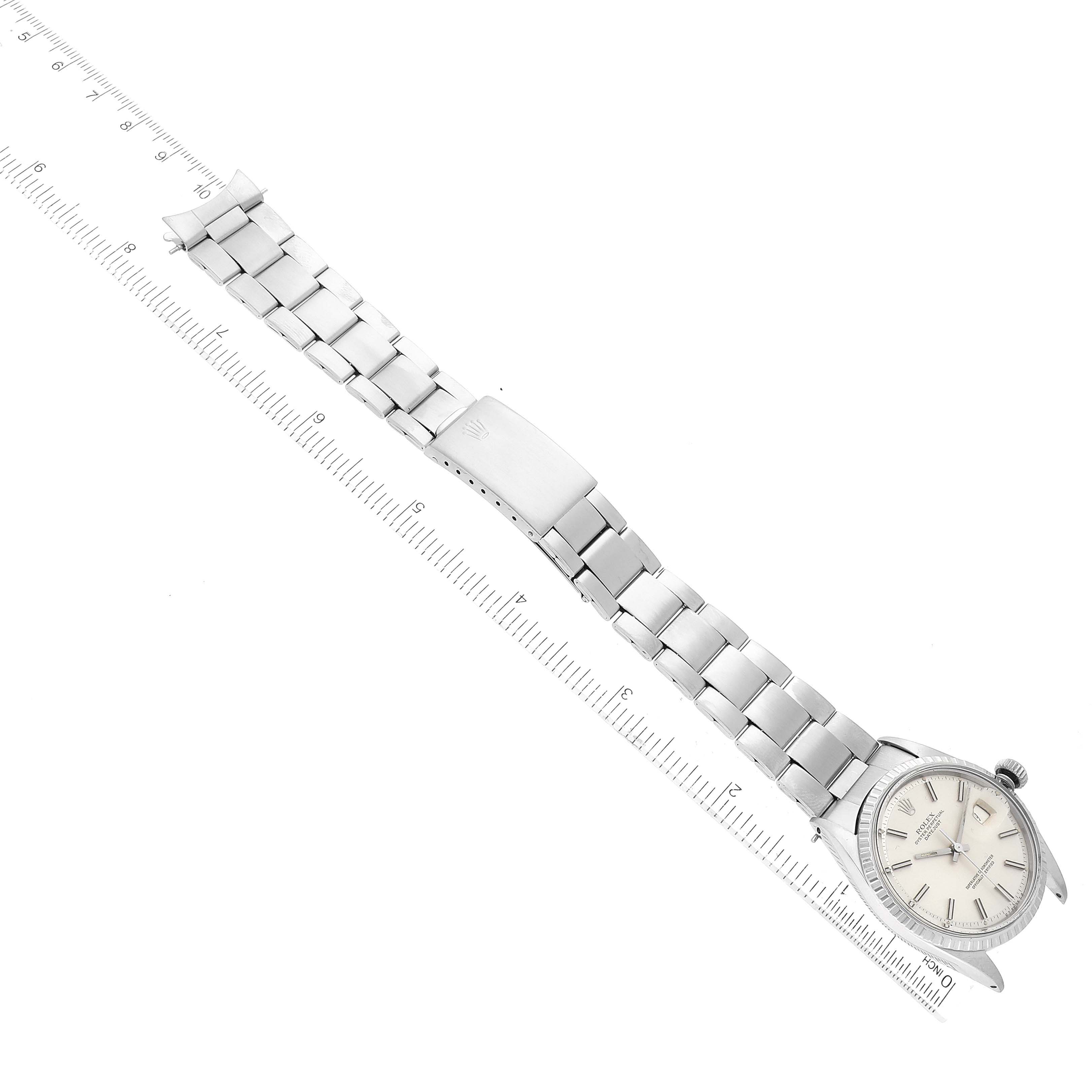 The image shows a vintage Rolex watch flat on a surface, displaying its face, stainless steel bracelet, and clasp.