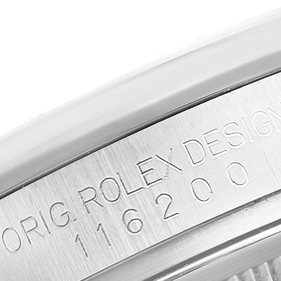 The image shows a close-up of the engraved case back design and model number "116200" of a Rolex Datejust 116200 Men's Stainless Steel Silver Dial 116200 Men's Stainless Steel Silver Dial watch.