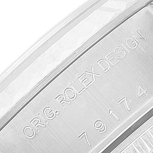 The image shows an angled close-up of the side engraving on a Rolex Datejust 79174 Women
s Stainless Steel Blue Dial 79174 Women
s Stainless Steel Blue Dial watch.