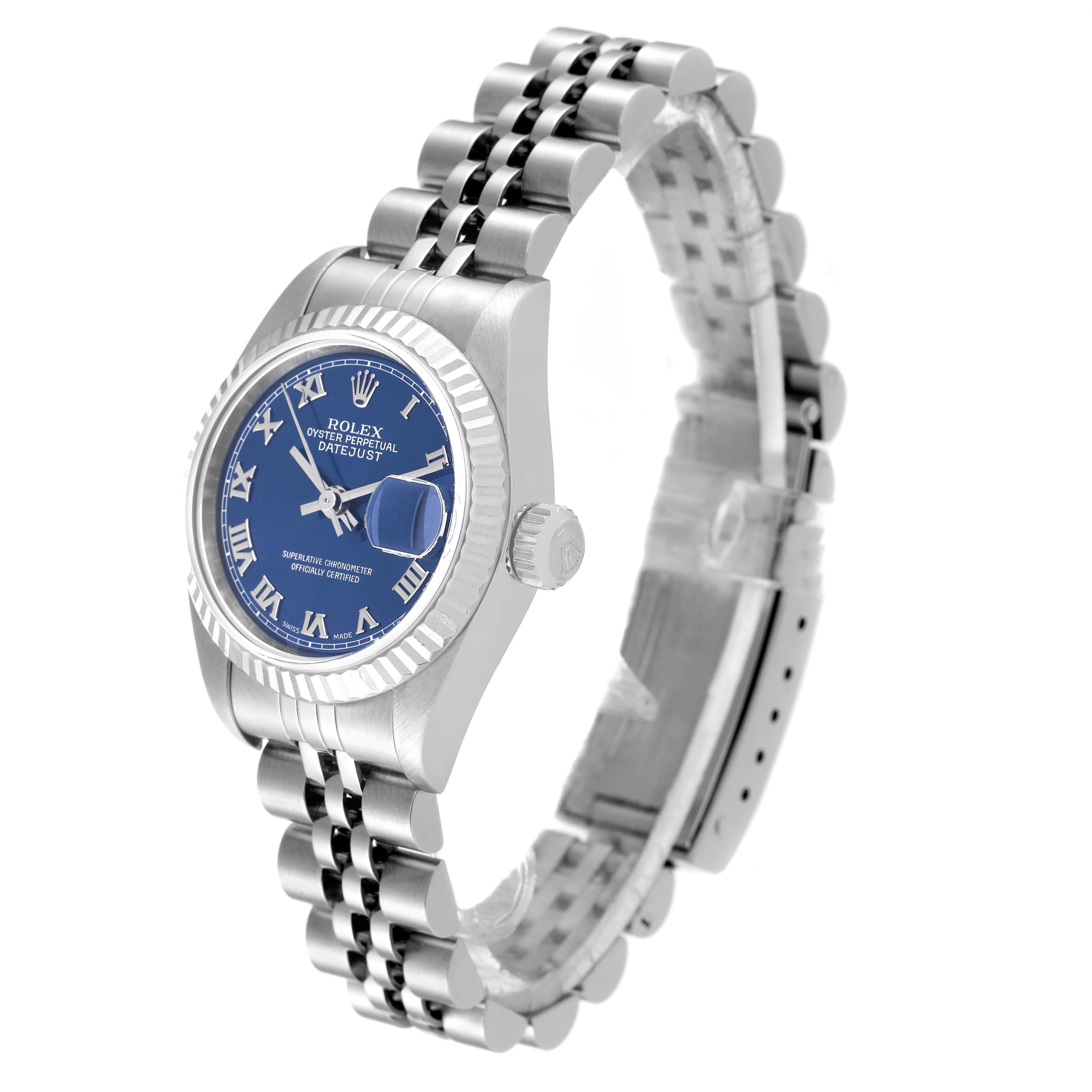 The Rolex Datejust 79174 Women
s Stainless Steel Blue Dial 79174 Women
s Stainless Steel Blue Dial watch is shown at a front-left angle, displaying its blue dial, Roman numerals, fluted bezel, and Jubilee bracelet.