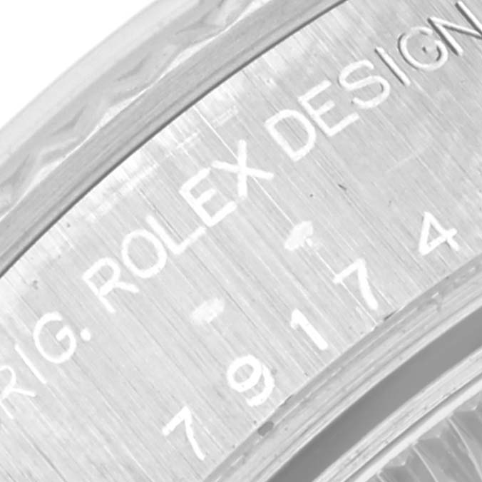 This image shows a close-up view of the serial number and engravings on the inner bezel of a Rolex Datejust 79174 Women's Stainless Steel Silver Dial 79174 Women's Stainless Steel Silver Dial watch.