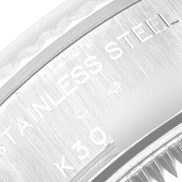 This is a close-up of a Rolex Datejust 79174 Women's Stainless Steel Silver Dial 79174 Women's Stainless Steel Silver Dial watch, showing the "Stainless Steel" engraving and part of the fluted bezel.