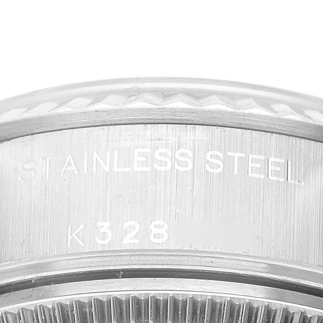 Close-up of the side of a Datejust Rolex watch showing stainless steel material and partial serial number.