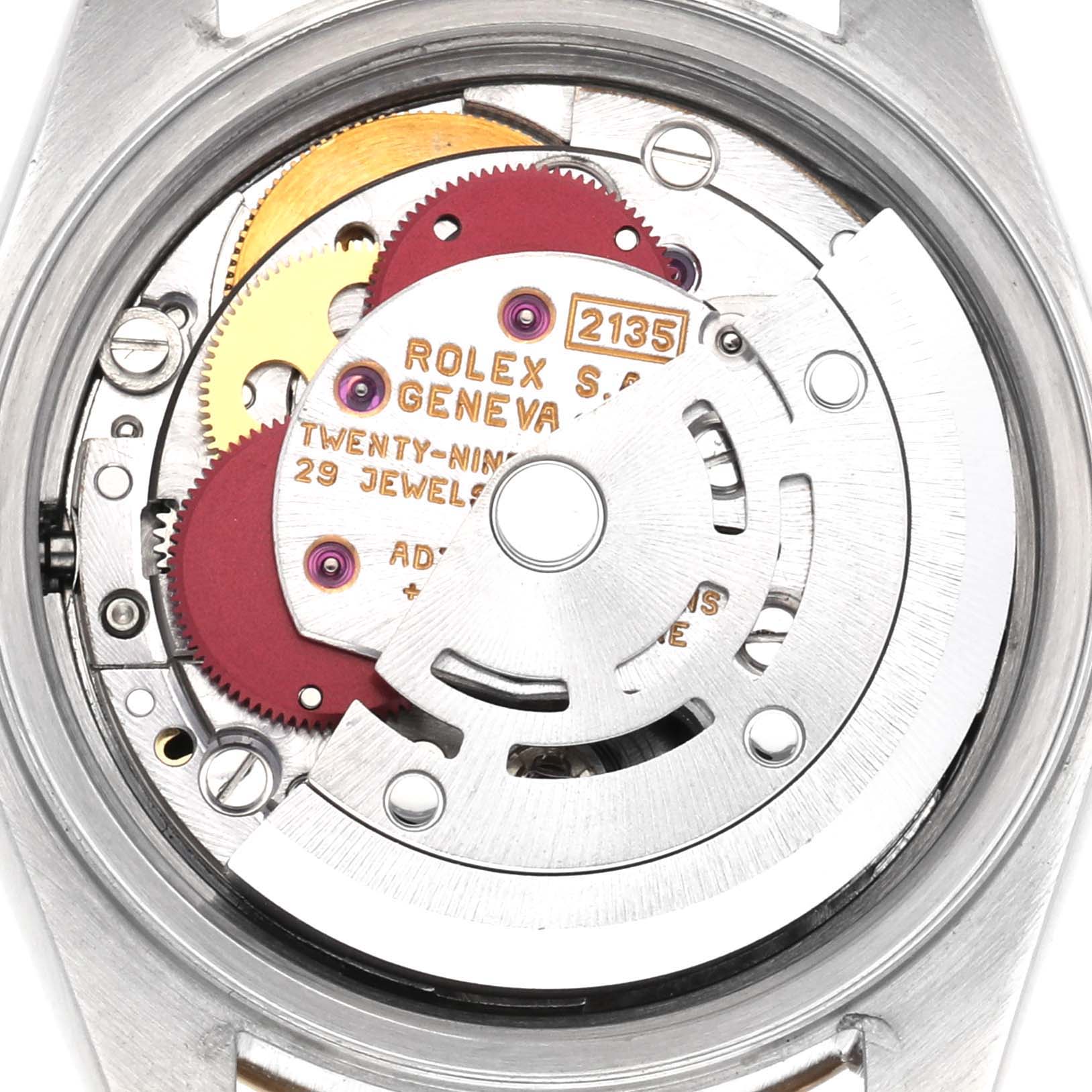 The image shows a close-up of the Rolex Datejust 69173 Women
s Steel and Gold (two tone) Black Dial 69173 Women
s Steel and Gold (two tone) Black Dial
s movement, displaying gears and intricate inner mechanisms.