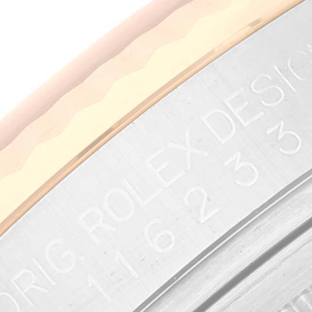 This image shows a close-up of the side engraving on the case back of a Rolex Datejust 116233 Men's Steel and Gold (two tone) Black Dial 116233 Men's Steel and Gold (two tone) Black Dial watch.