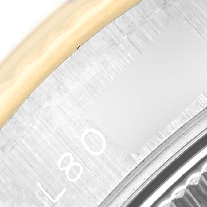 Close-up of the dial and bezel area of a Rolex Datejust 69173 Women's Steel and Gold (two tone) Black Dial 69173 Women's Steel and Gold (two tone) Black Dial watch, showing part of the engraved numbers and fluted bezel.