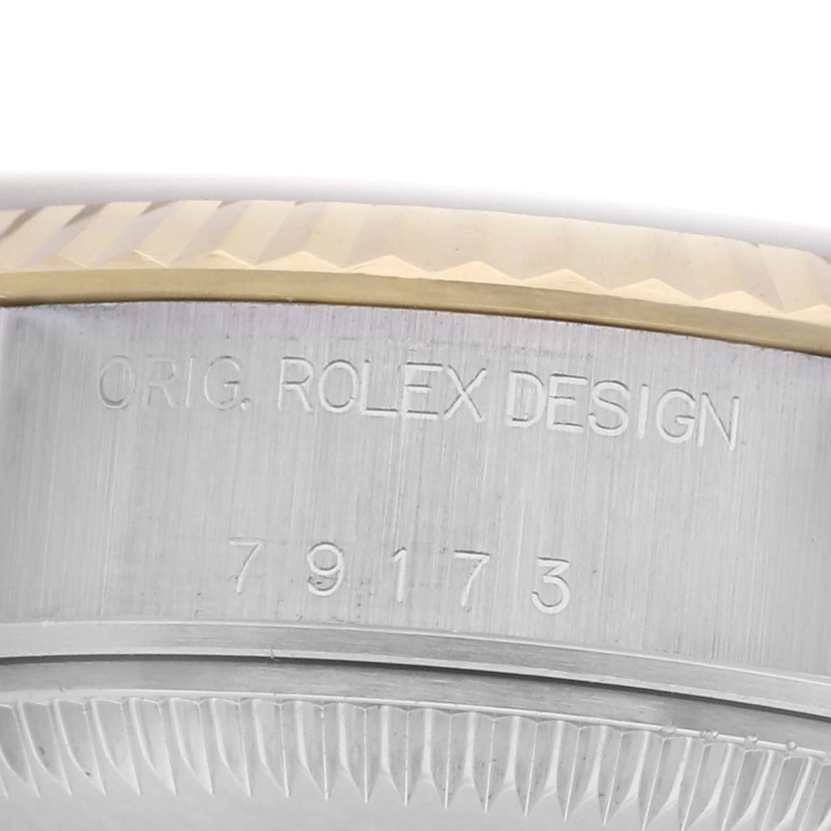 The image shows the side of the Rolex Datejust 79173 Women
s Steel and Gold (two tone) Champagne Dial 79173 Women
s Steel and Gold (two tone) Champagne Dial watch case with engraved numbers and text.