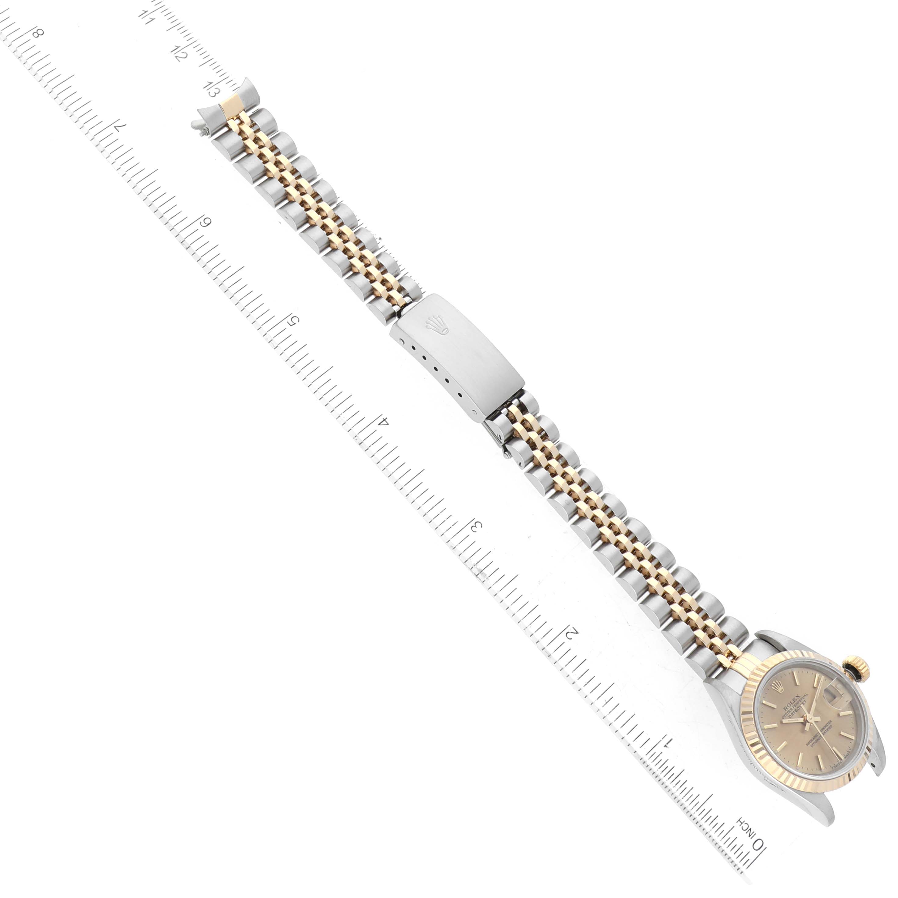 The image shows a top-down view of a Rolex Datejust 69173 Women's Steel and Gold (two tone) Champagne Dial 69173 Women's Steel and Gold (two tone) Champagne Dial watch, focusing on the bracelet and clasp with a ruler for measurement.