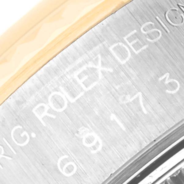 This image shows a close-up view of the edge of the bezel and the case back engraving of a Rolex Datejust 69173 Women's Steel and Gold (two tone) Champagne Dial 69173 Women's Steel and Gold (two tone) Champagne Dial watch.