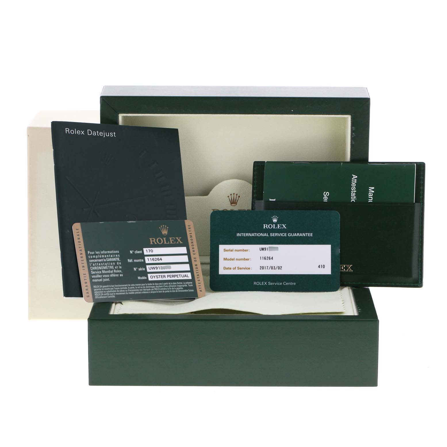 This image shows the packaging and documentation for a Rolex Turn-o-Graph 116264 Men
s Stainless Steel Blue Dial 116264 Men
s Stainless Steel Blue Dial watch, including certificates and booklets.