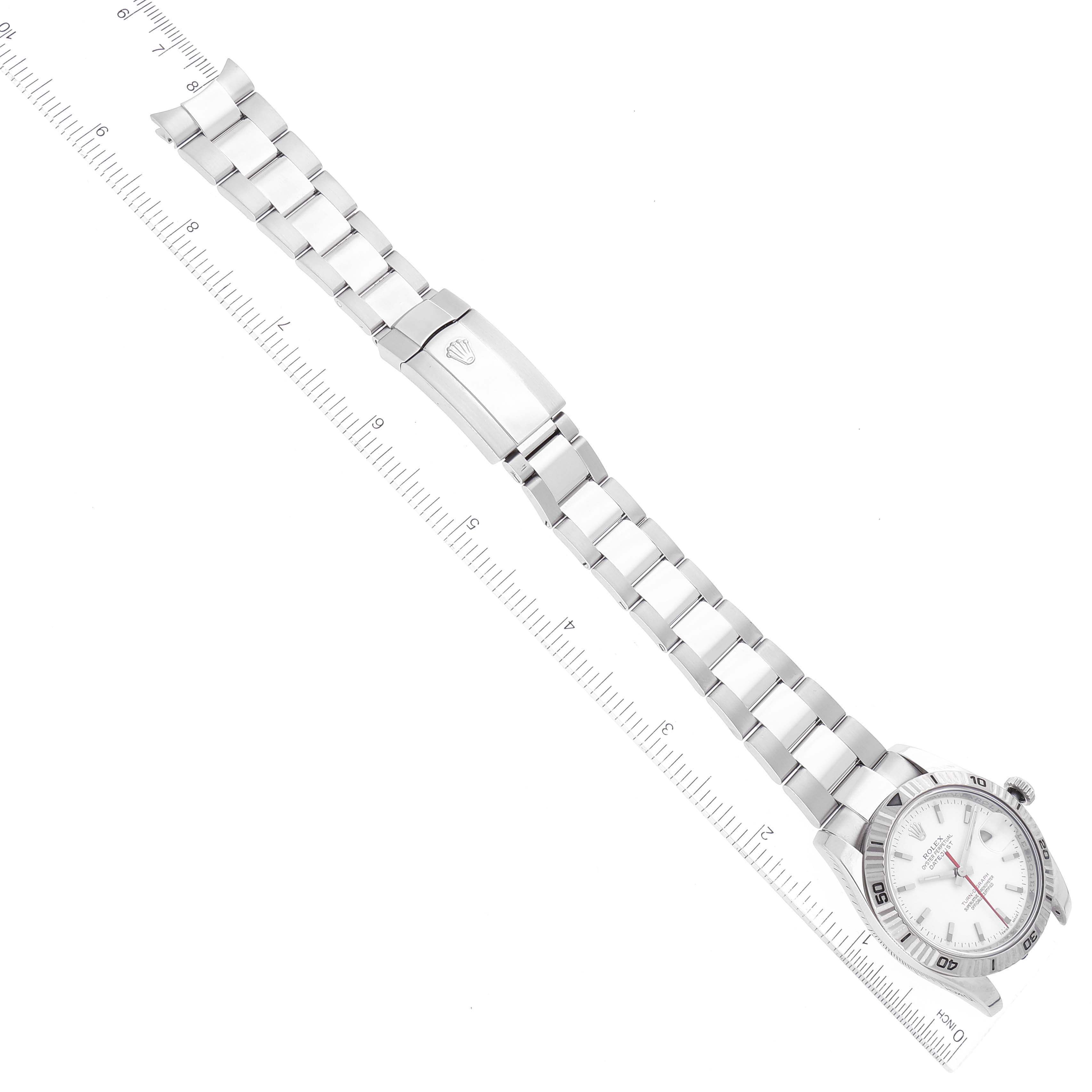 The image shows a Rolex Turn-o-Graph 116264 Men's Stainless Steel White Dial 116264 Men's Stainless Steel White Dial watch laid flat with its face, bezel, and bracelet visible along with a ruler for scale.