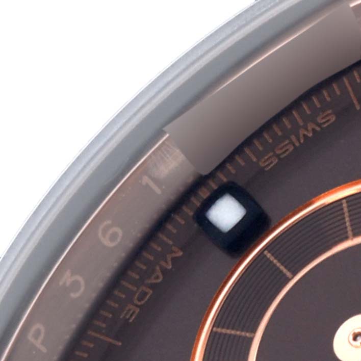 The image shows a close-up of the bezel and part of the face of a Rolex Daytona 116515 Men
s Rose Gold Brown Dial 116515 Men
s Rose Gold Brown Dial watch, highlighting the edge and numerals.
