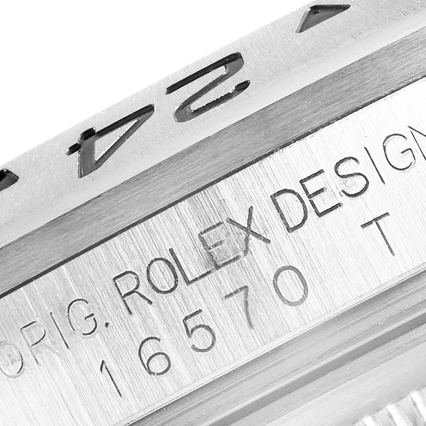 This image shows a close-up view of the bezel and case with engravings on a Rolex Explorer 16570 Men's Stainless Steel White Dial 16570 Men's Stainless Steel White Dial model.