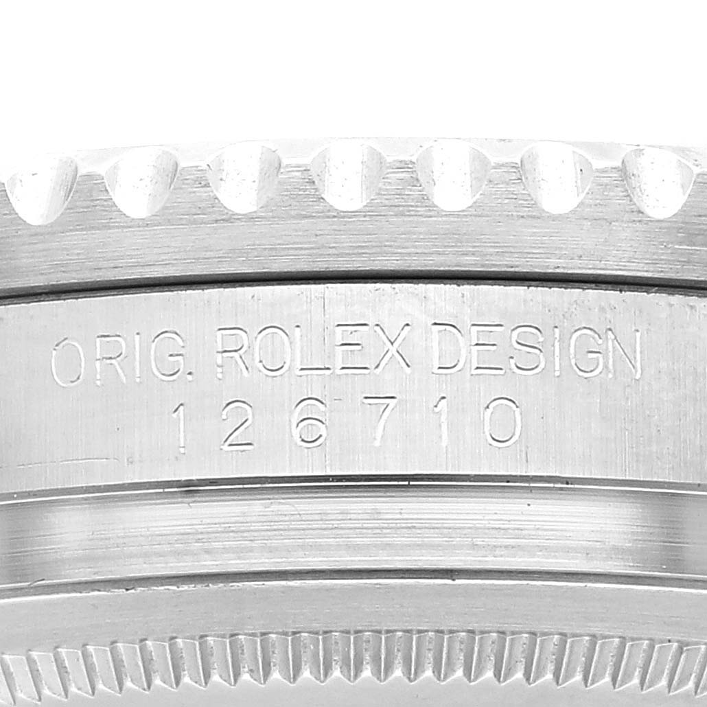 The image shows a close-up view of the case side of a Rolex GMT-Master 126710BLNR Men's Stainless Steel Black Dial 126710BLNR Men's Stainless Steel Black Dial, displaying the model number and design engraving.