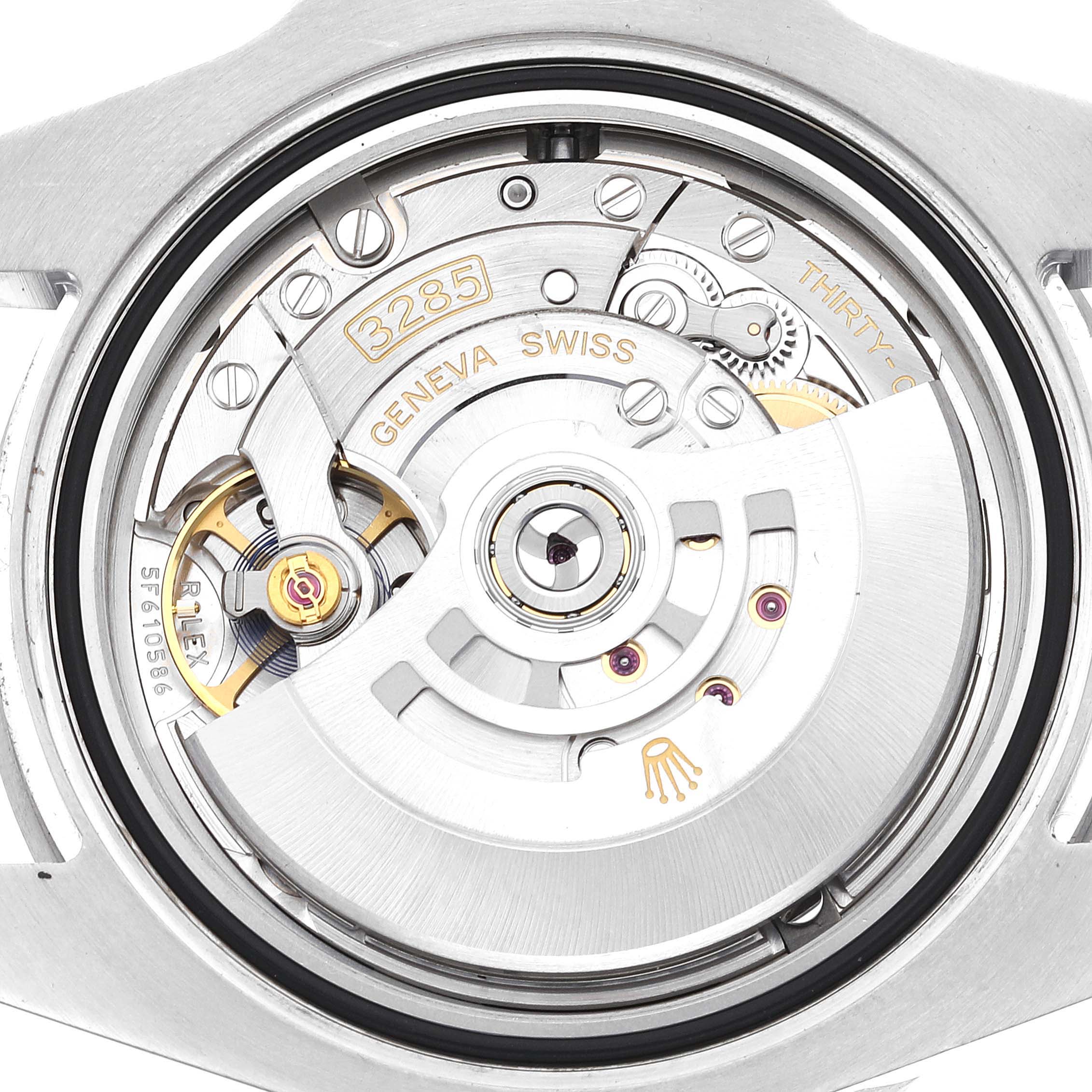 This image shows a close-up view of the movement mechanism of a Rolex GMT-Master 126710BLNR Men's Stainless Steel Black Dial 126710BLNR Men's Stainless Steel Black Dial watch, showcasing the components and engravings.