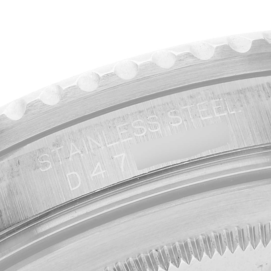 This image shows a close-up angle of the Rolex GMT-Master 16710 Men's Stainless Steel Black Dial 16710 Men's Stainless Steel Black Dial watch case, highlighting the bezel and engraved serial number.