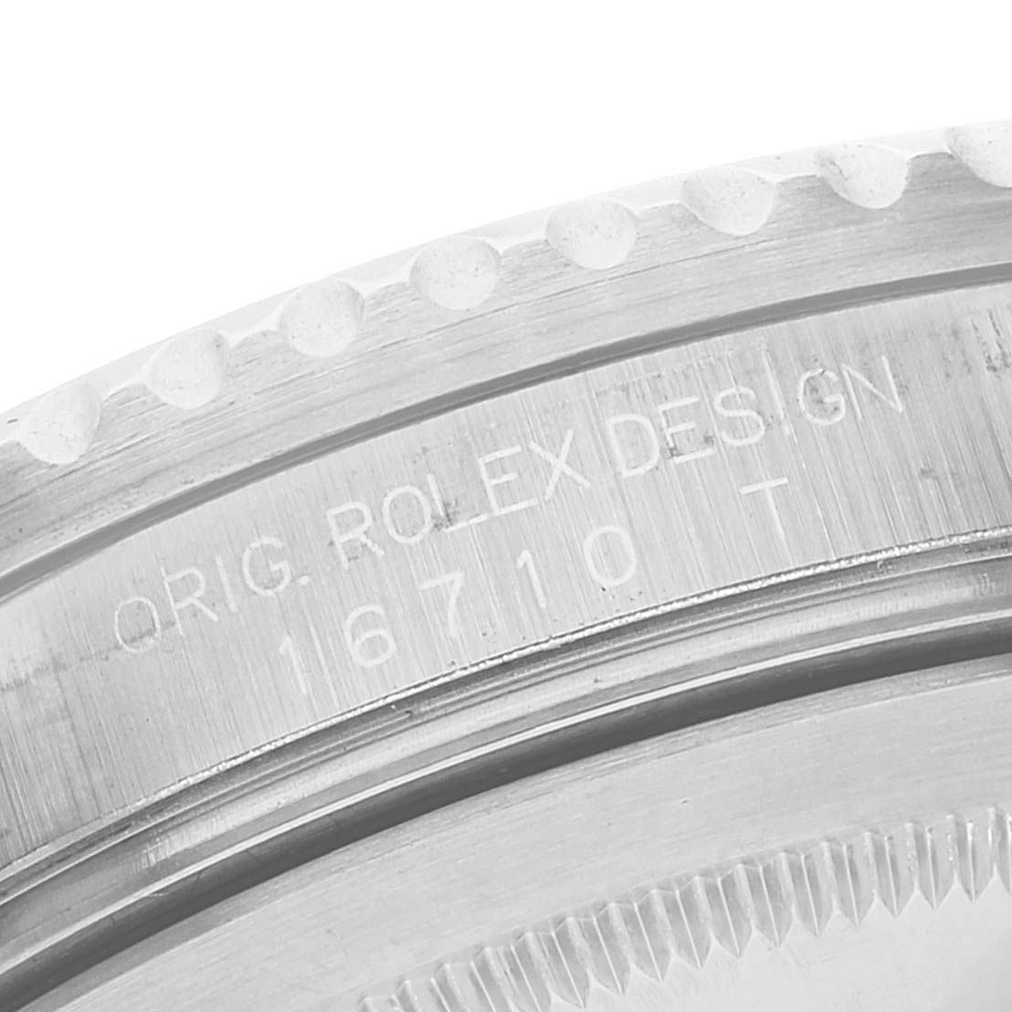 The image shows a close-up of the engraved case and bezel of a Rolex GMT-Master 16710 Men's Stainless Steel Black Dial 16710 Men's Stainless Steel Black Dial watch.