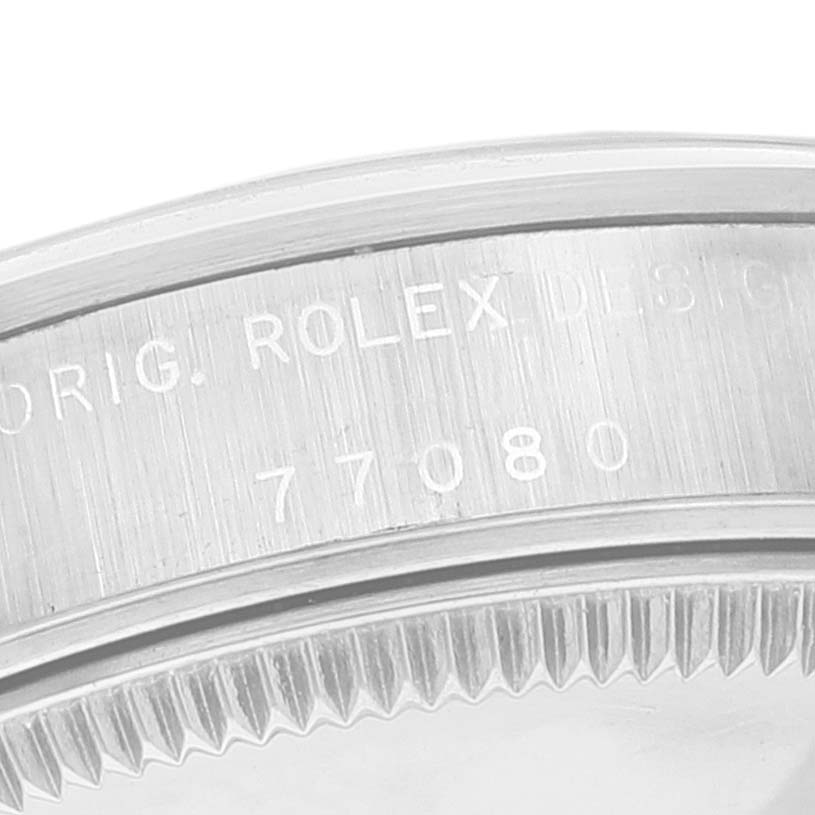 The image shows the side edge of a Rolex Mid-Size 77080 Women
s Stainless Steel Silver Dial 77080 Women
s Stainless Steel Silver Dial watch case with a visible model number 77080.