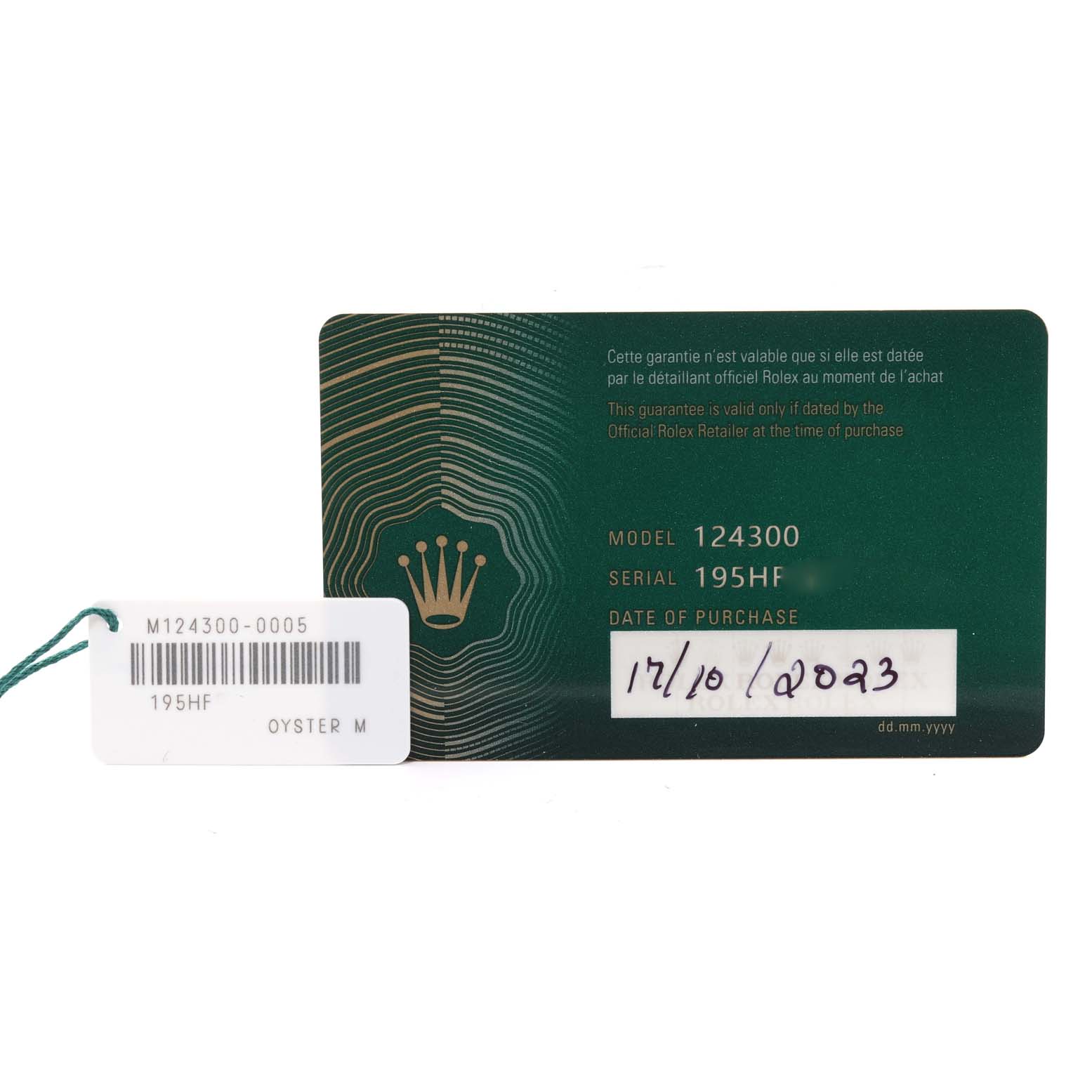 This image shows the warranty card and tag for the Rolex Oyster Perpetual 124300 Men's Stainless Steel Green Dial 124300 Men's Stainless Steel Green Dial model 124300, including serial number and purchase date.